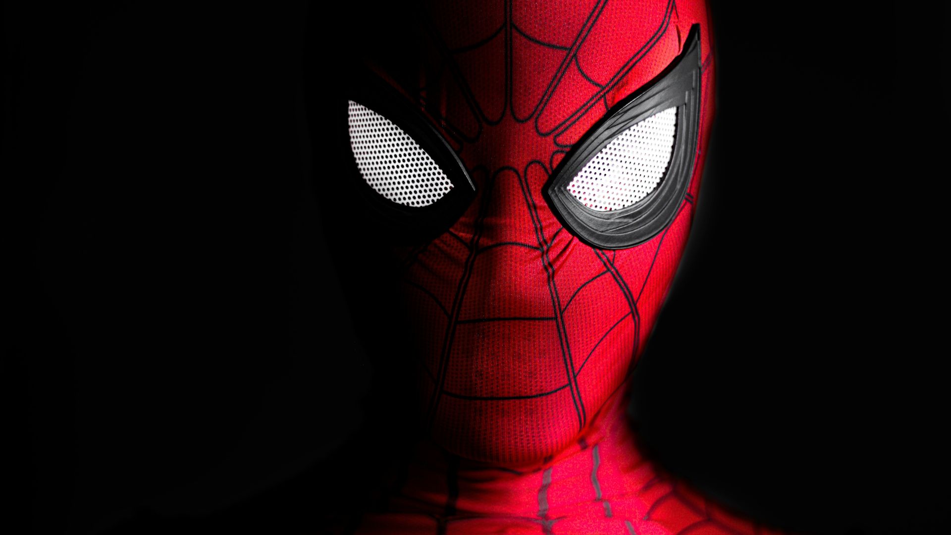 a close up of a spider man with glowing eyes