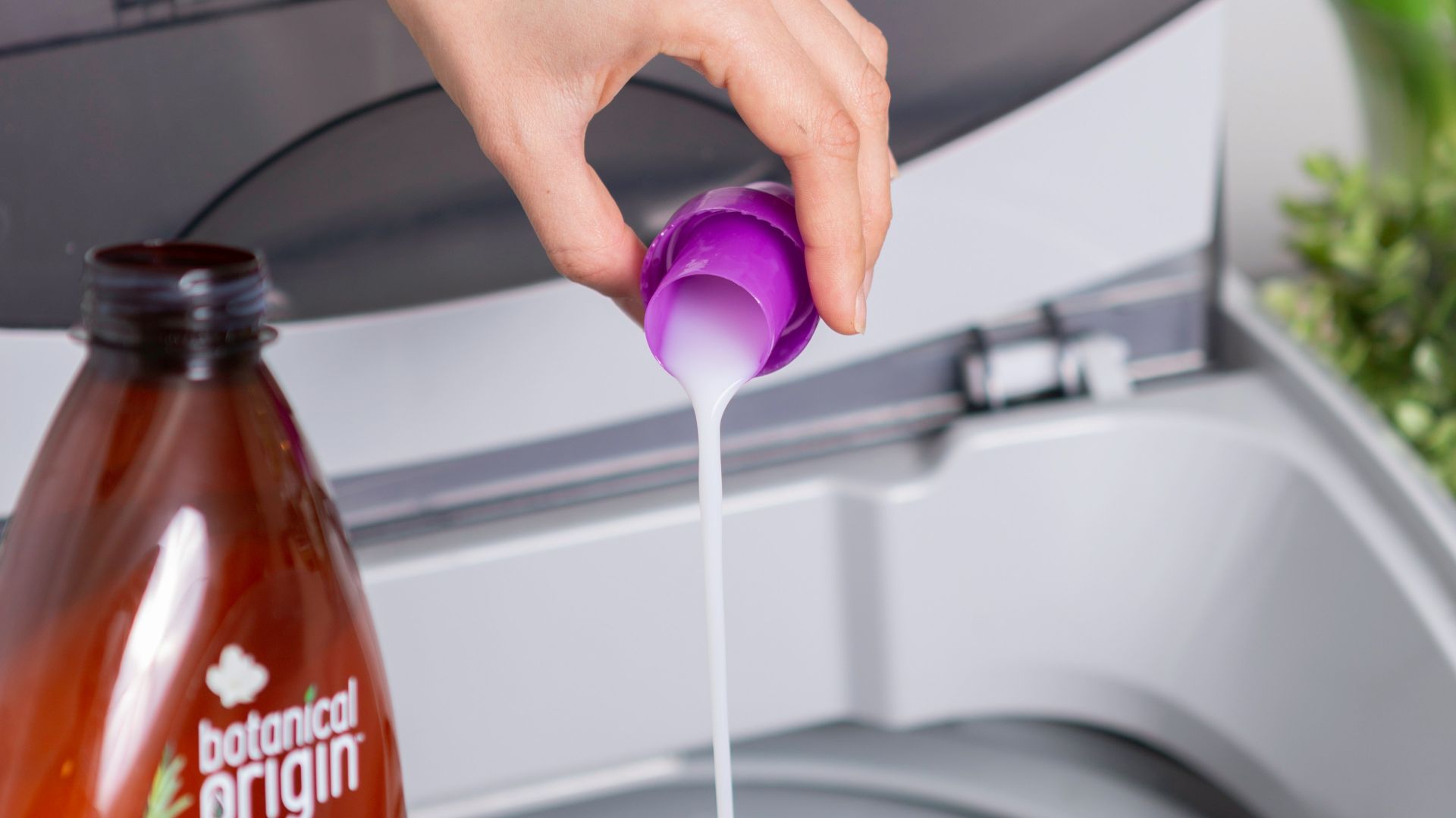 person holding purple plastic bottle