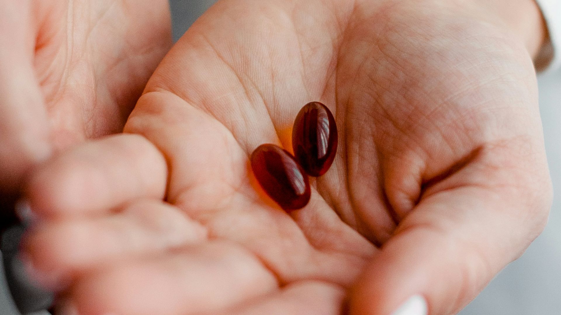 person holding brown and black round ornament
