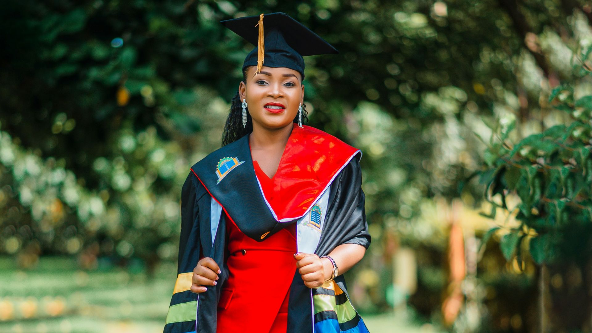 A woman in a graduation gown standing on a path