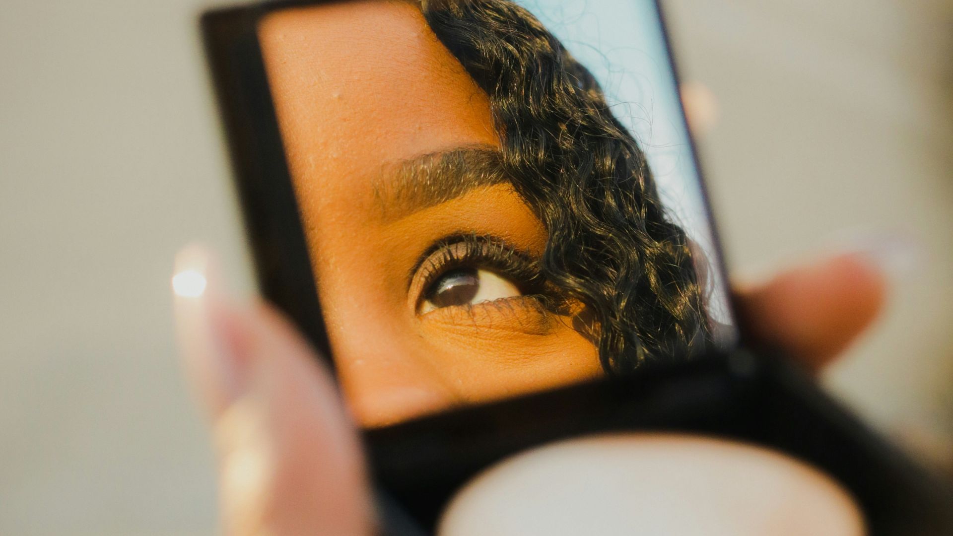 a woman holding a compact compact compact compact compact compact compact compact compact compact compact compact