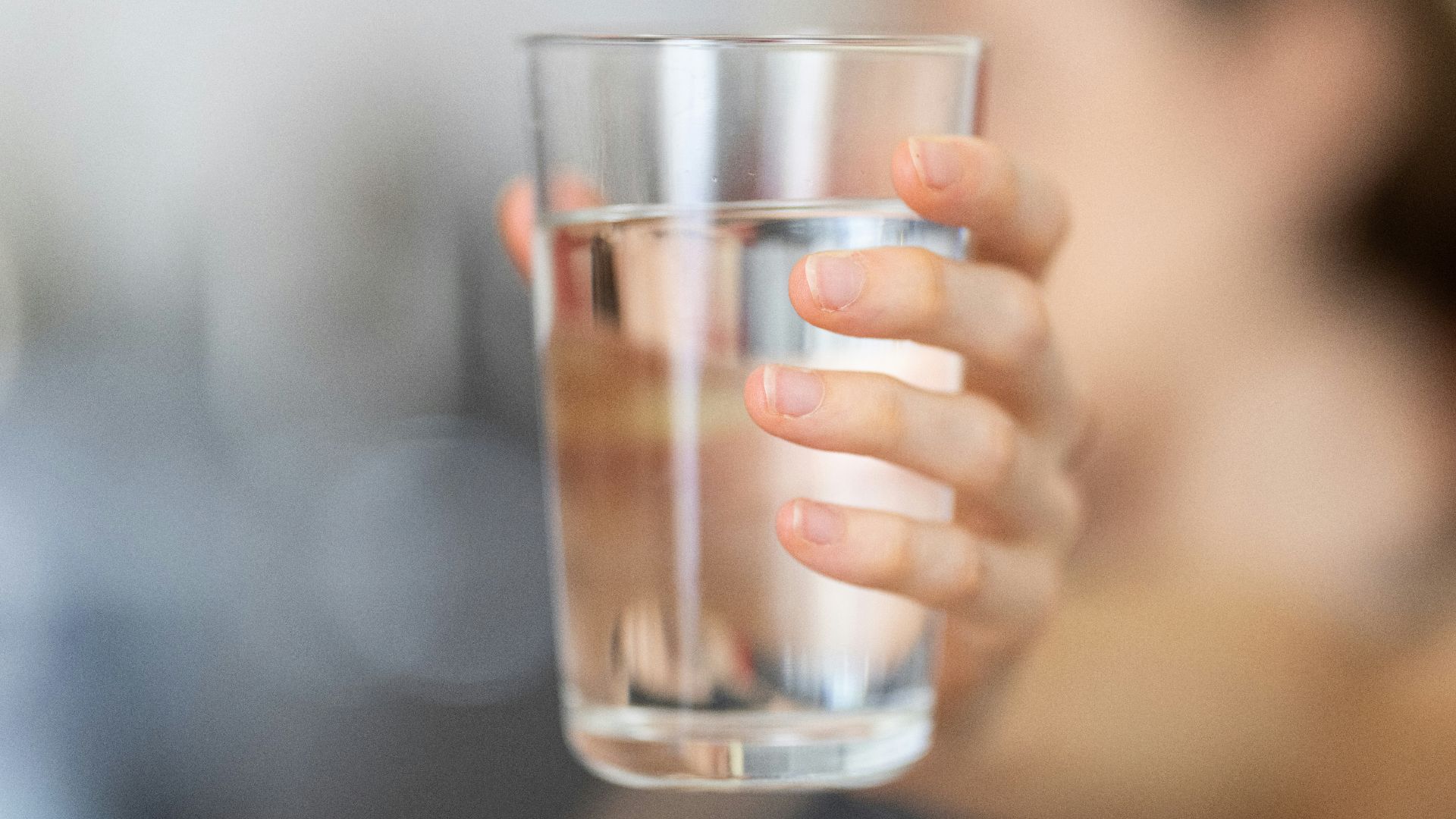 person holding clear drinking glass