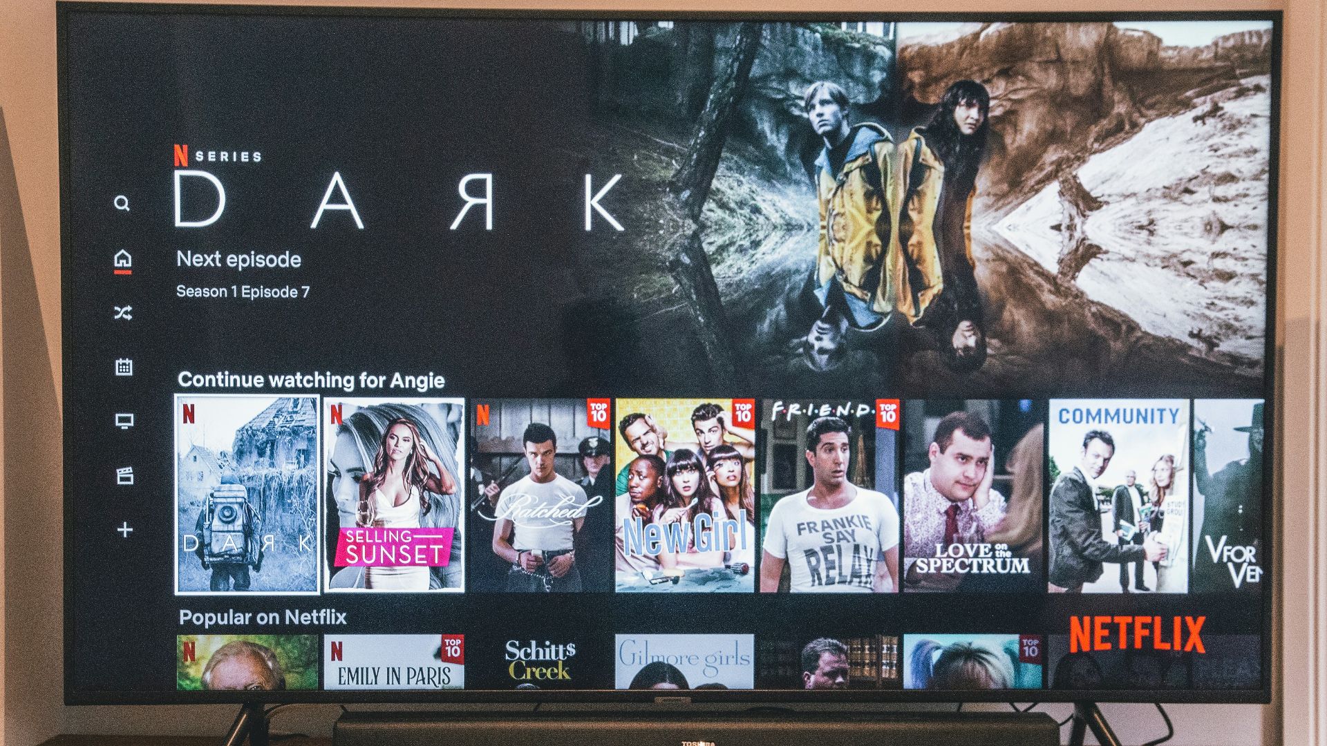 black flat screen tv turned on displaying man in black suit