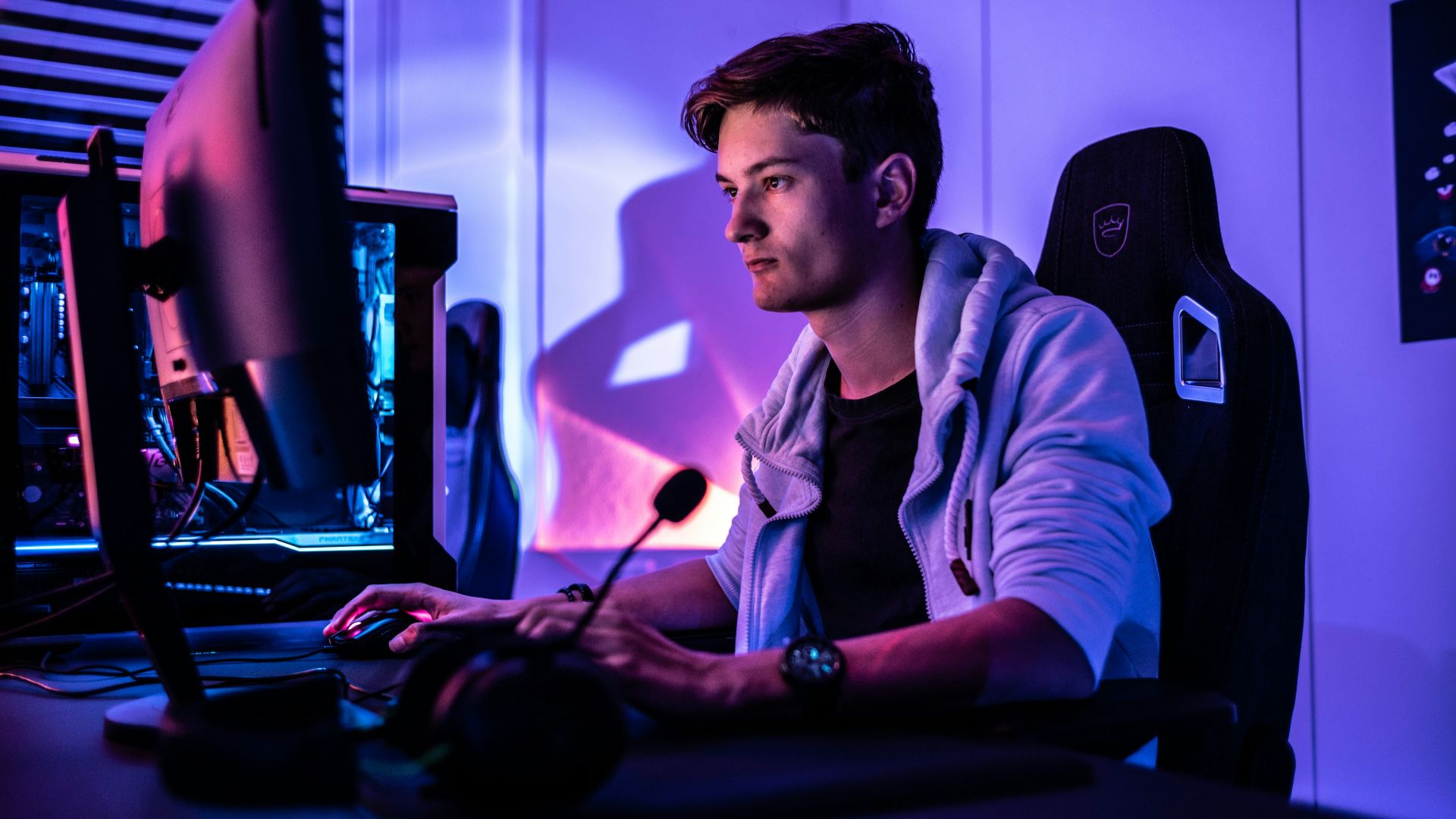 a man sitting in front of a computer monitor