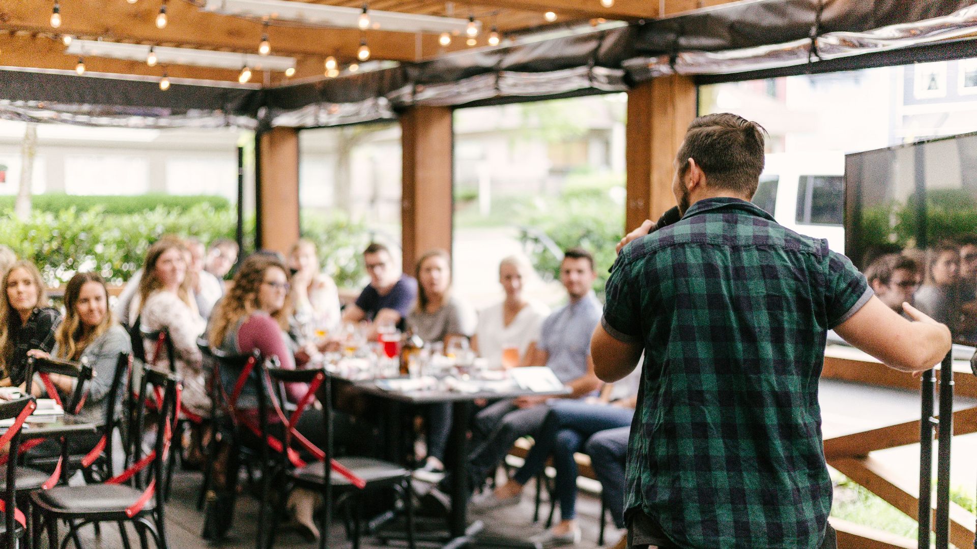 man standing infront of group of people