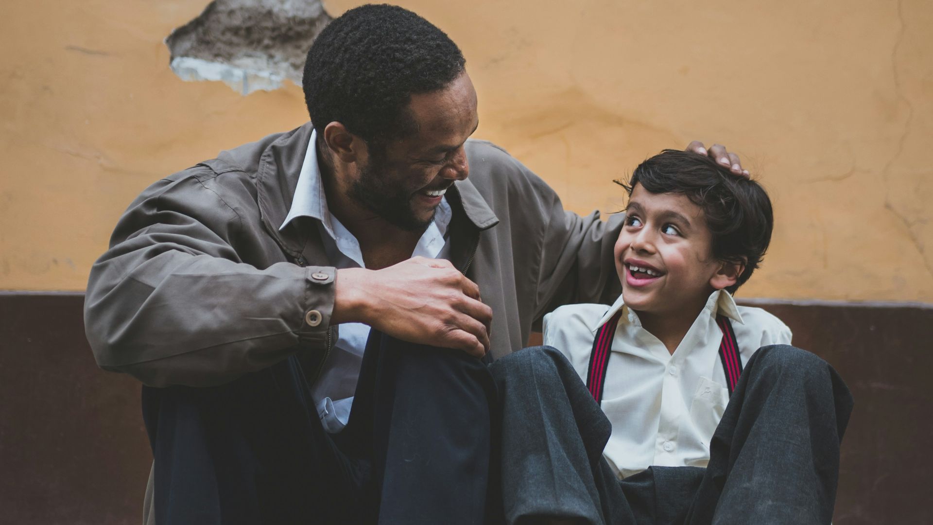 man holding boy's head