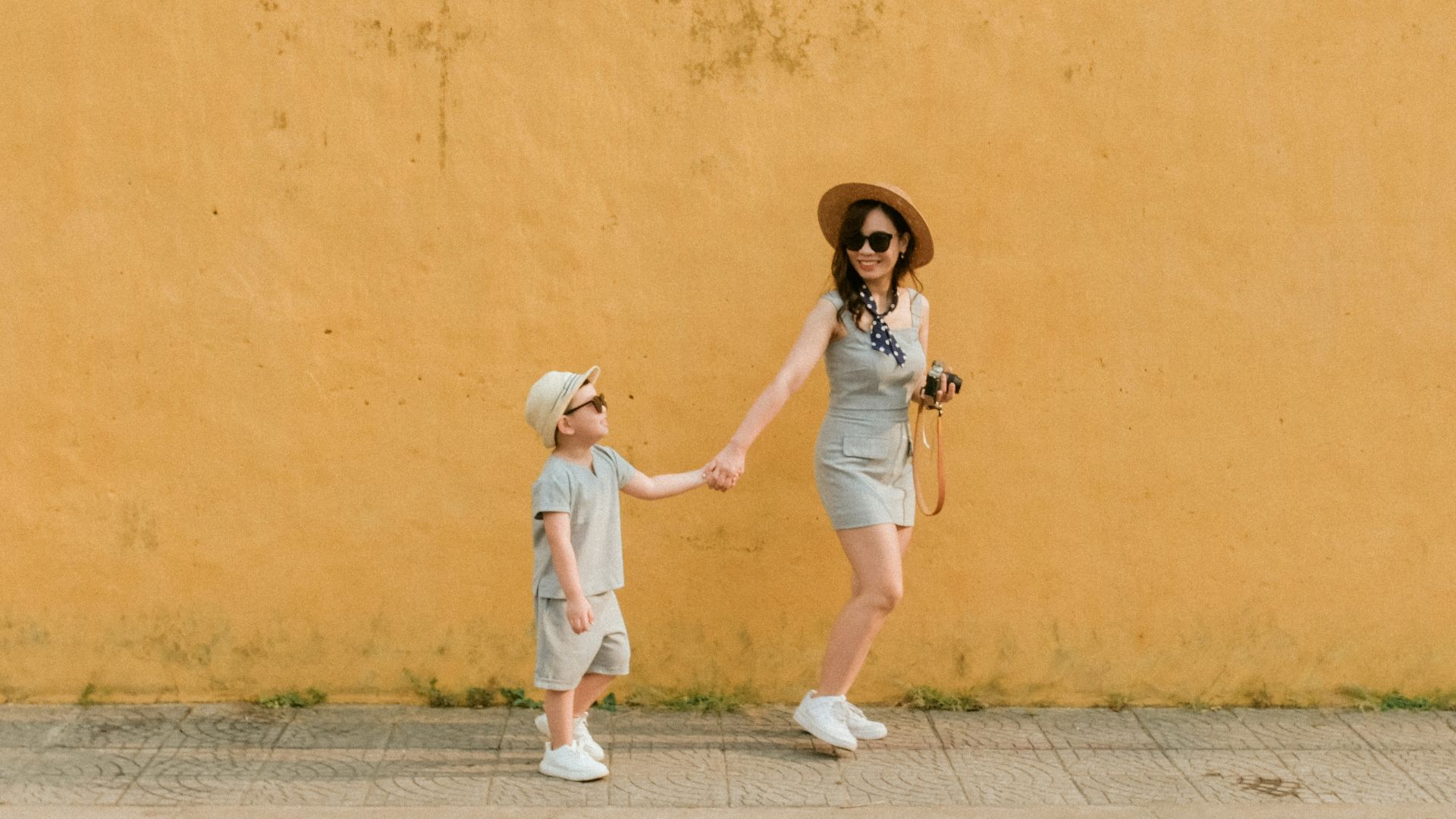 girl in white dress running on gray concrete road during daytime