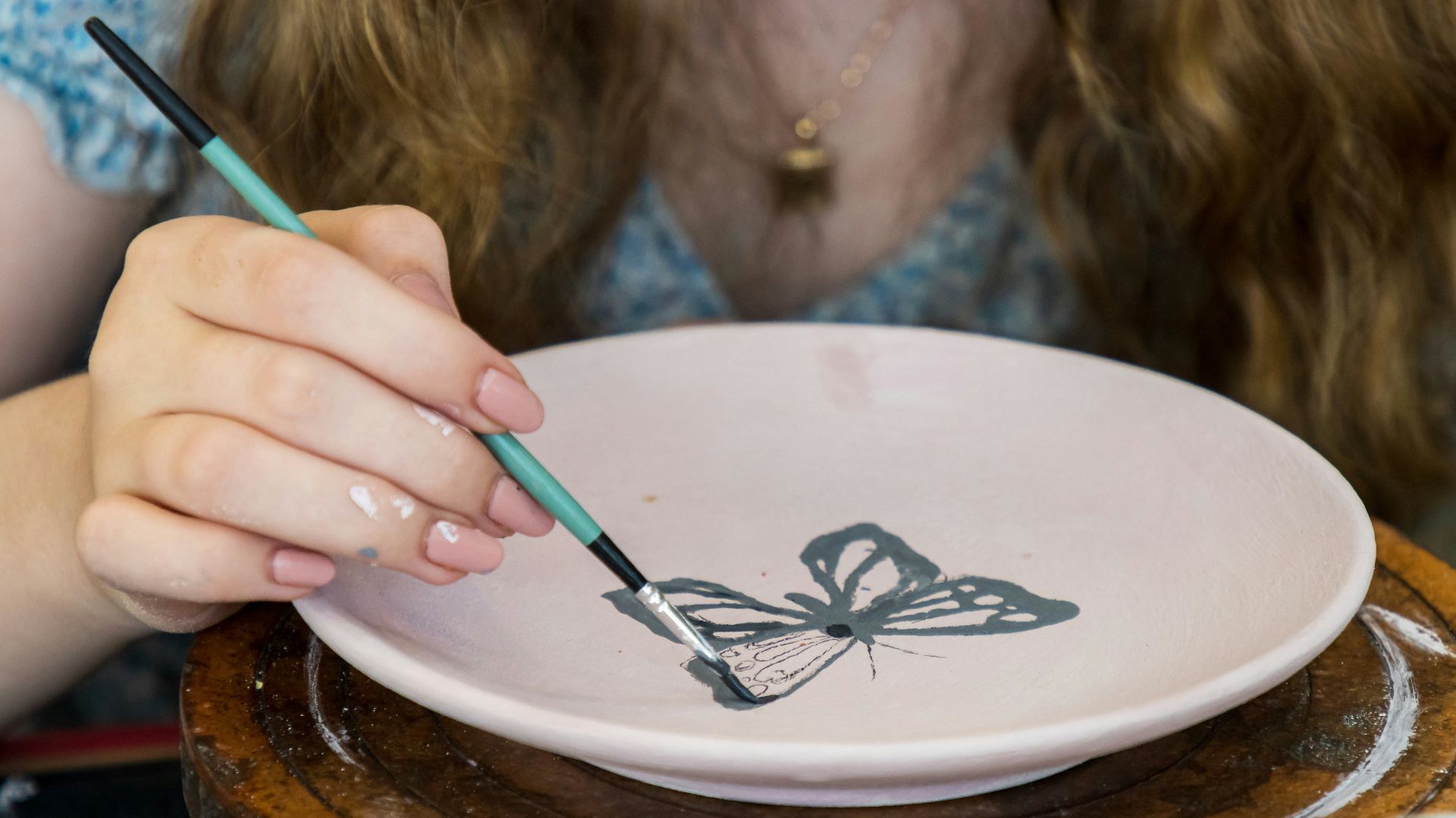 a child painting a bowl