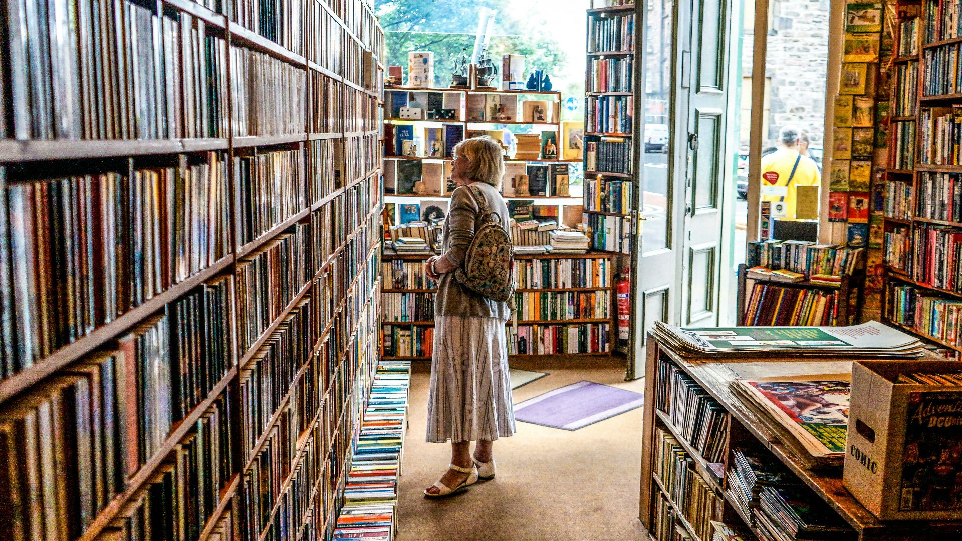 woman inside library looking at books