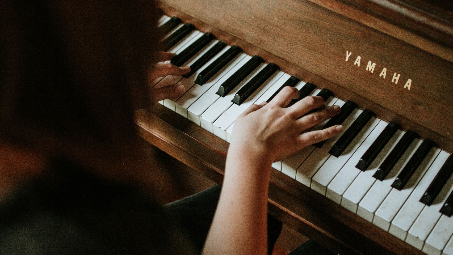 woman playing Yamaha piano