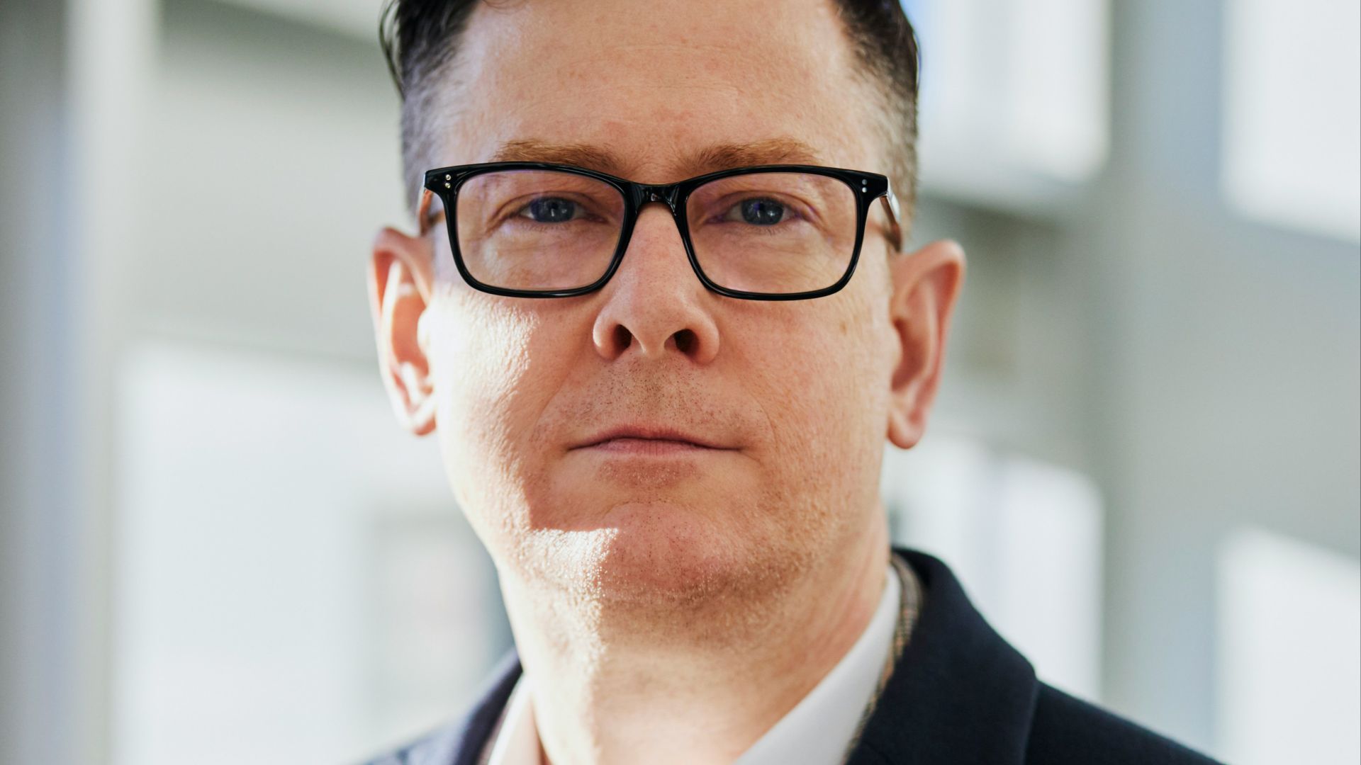 man standing beside wall