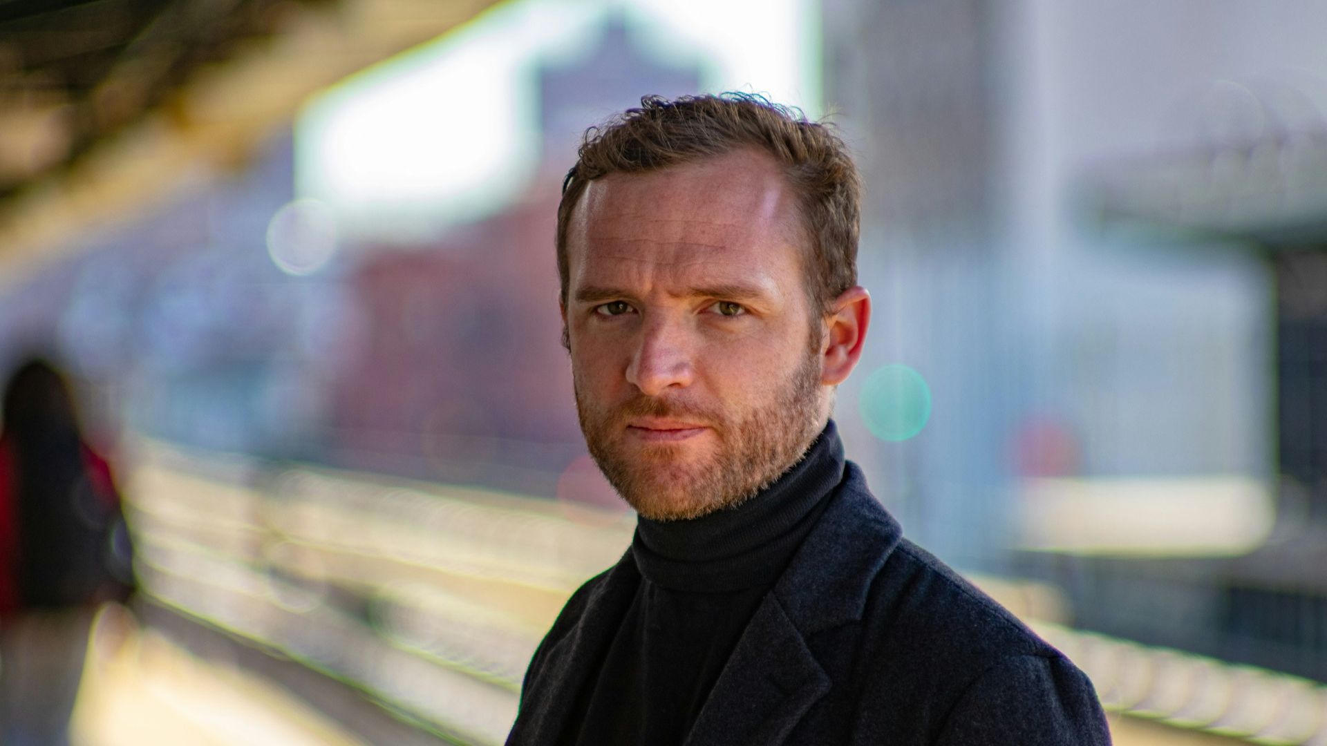 man wearing black notched lapel suit jacket