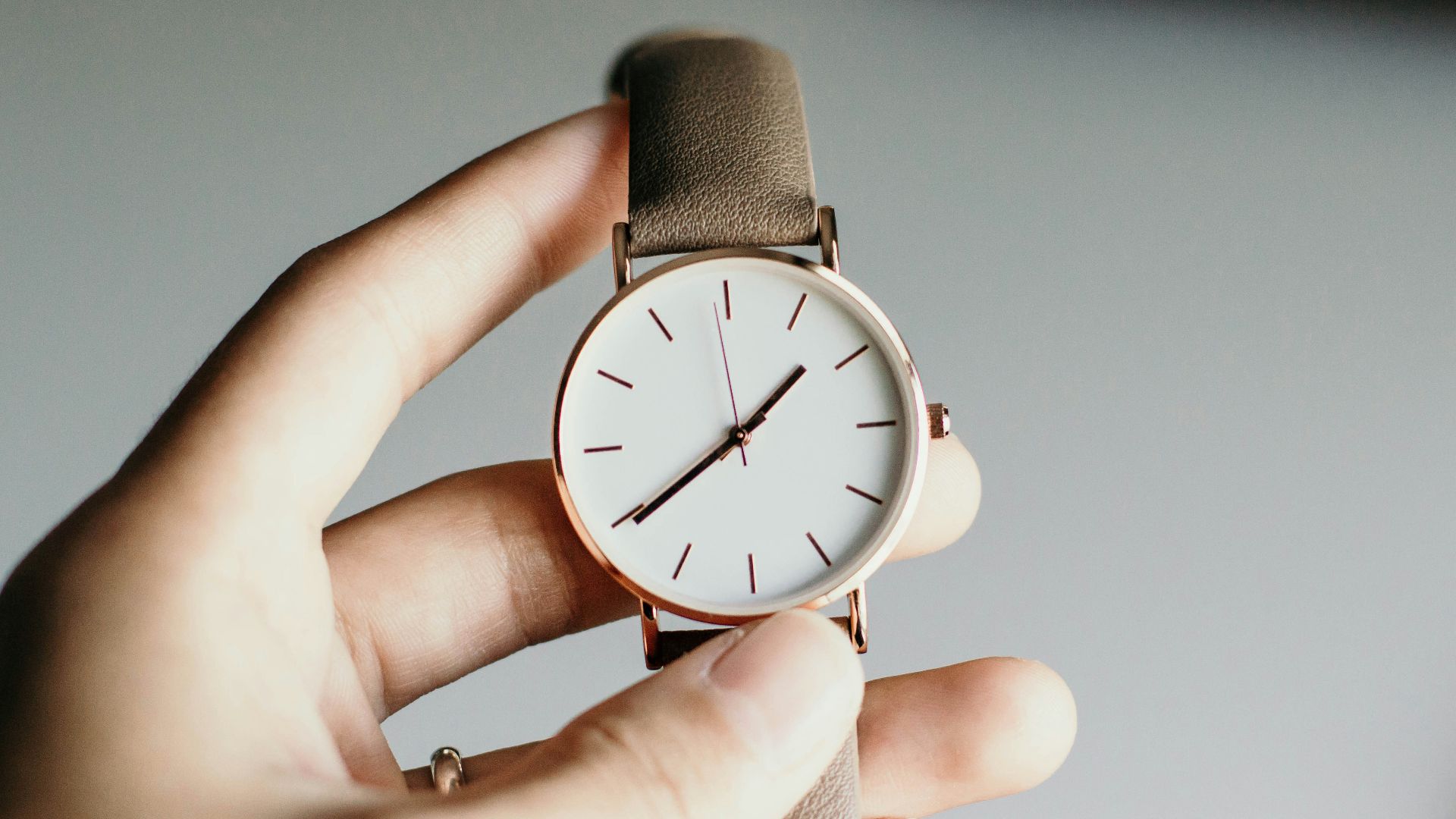 person holding analog watch