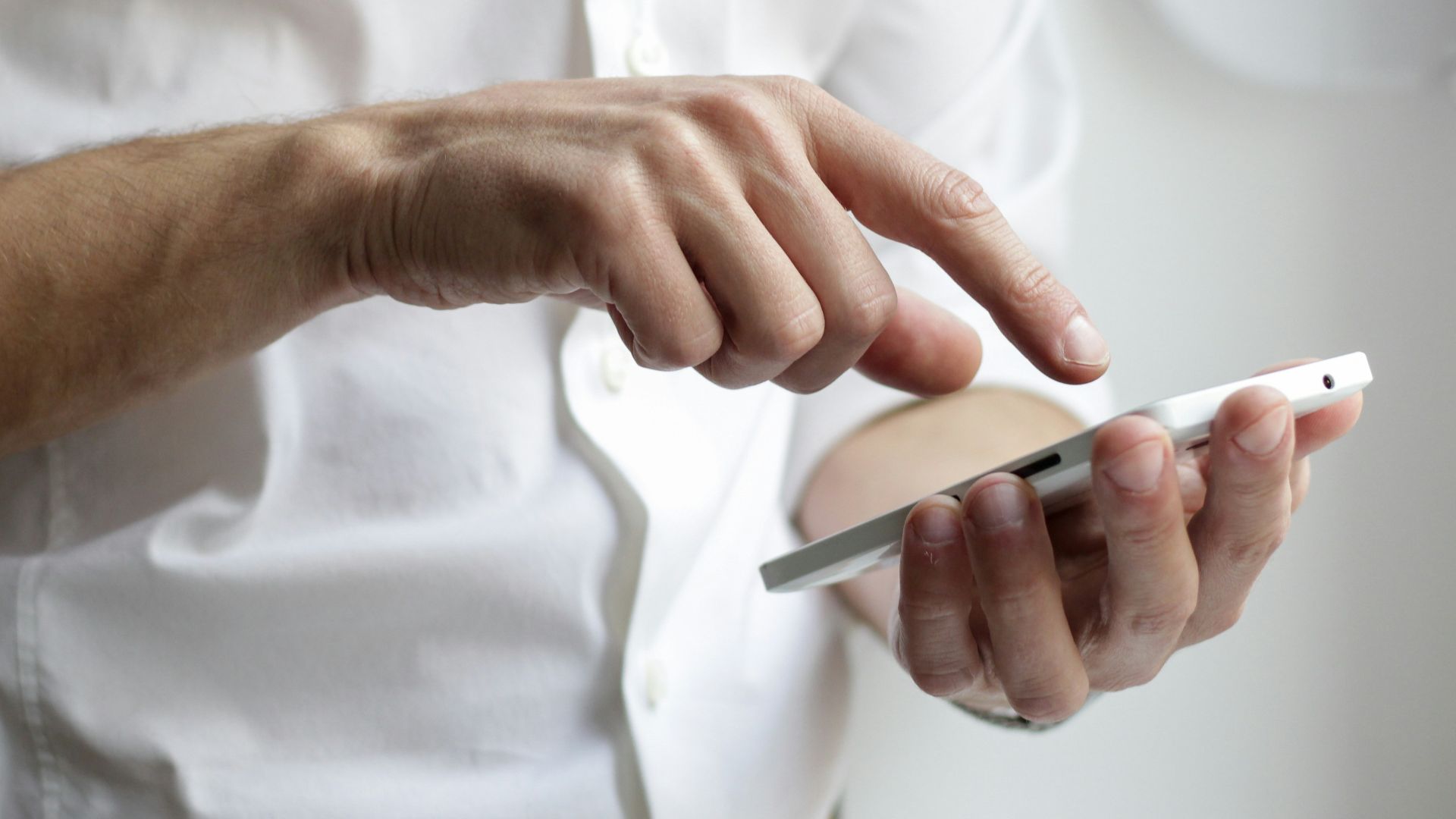 person holding white Android smartphone in white shirt