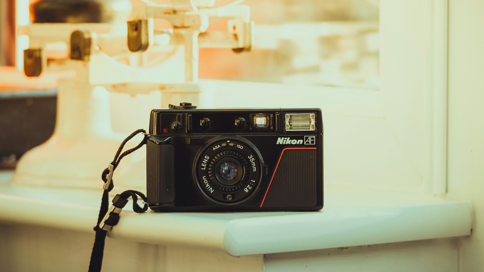 A camera sitting on top of a counter next to a window