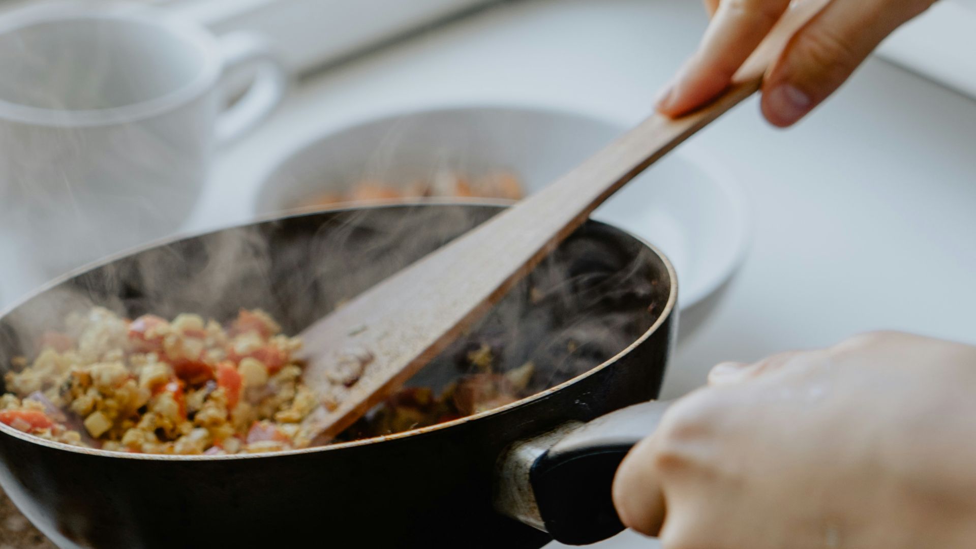 person holding black frying pan