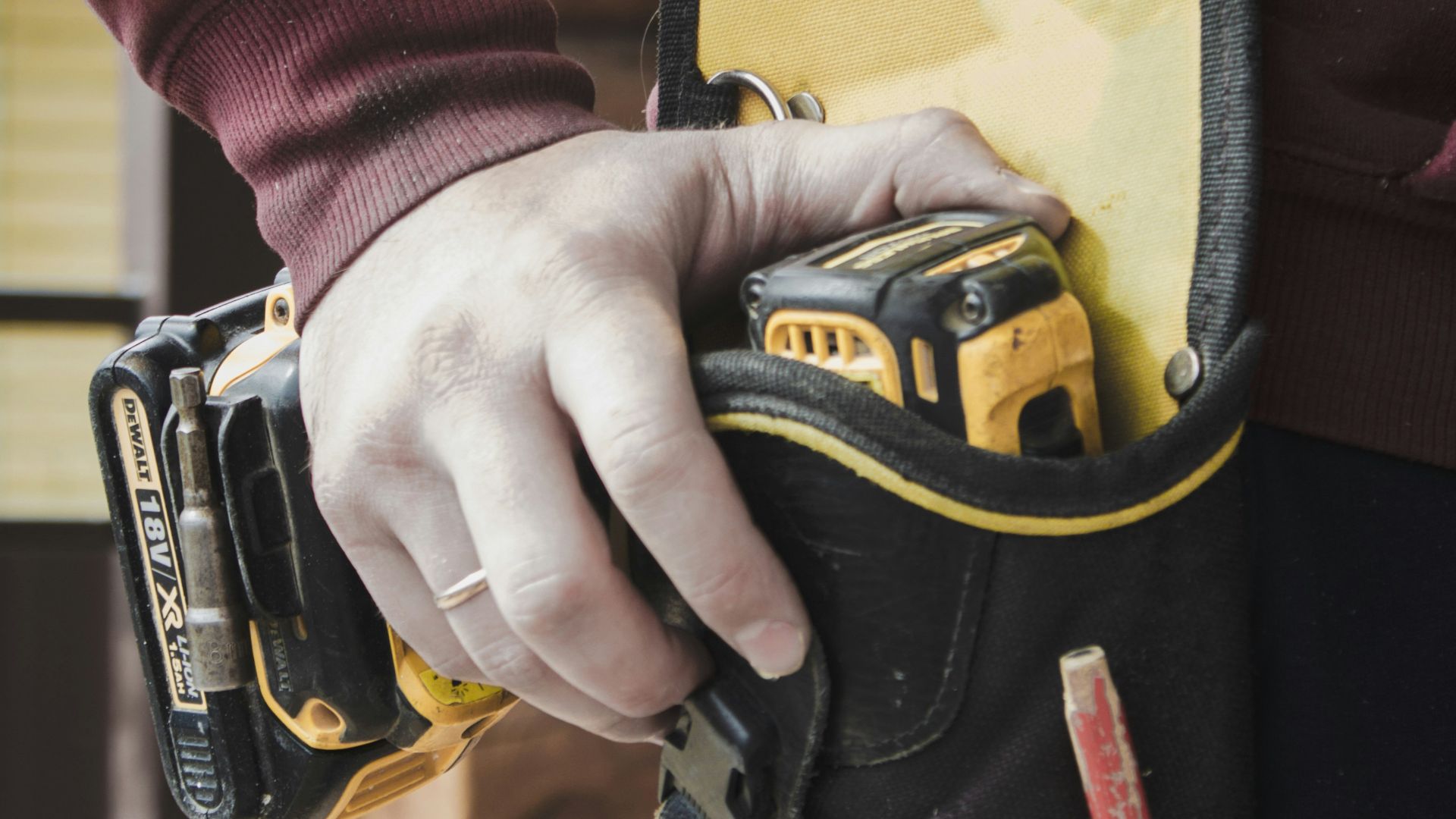 person holding black and yellow nike gloves