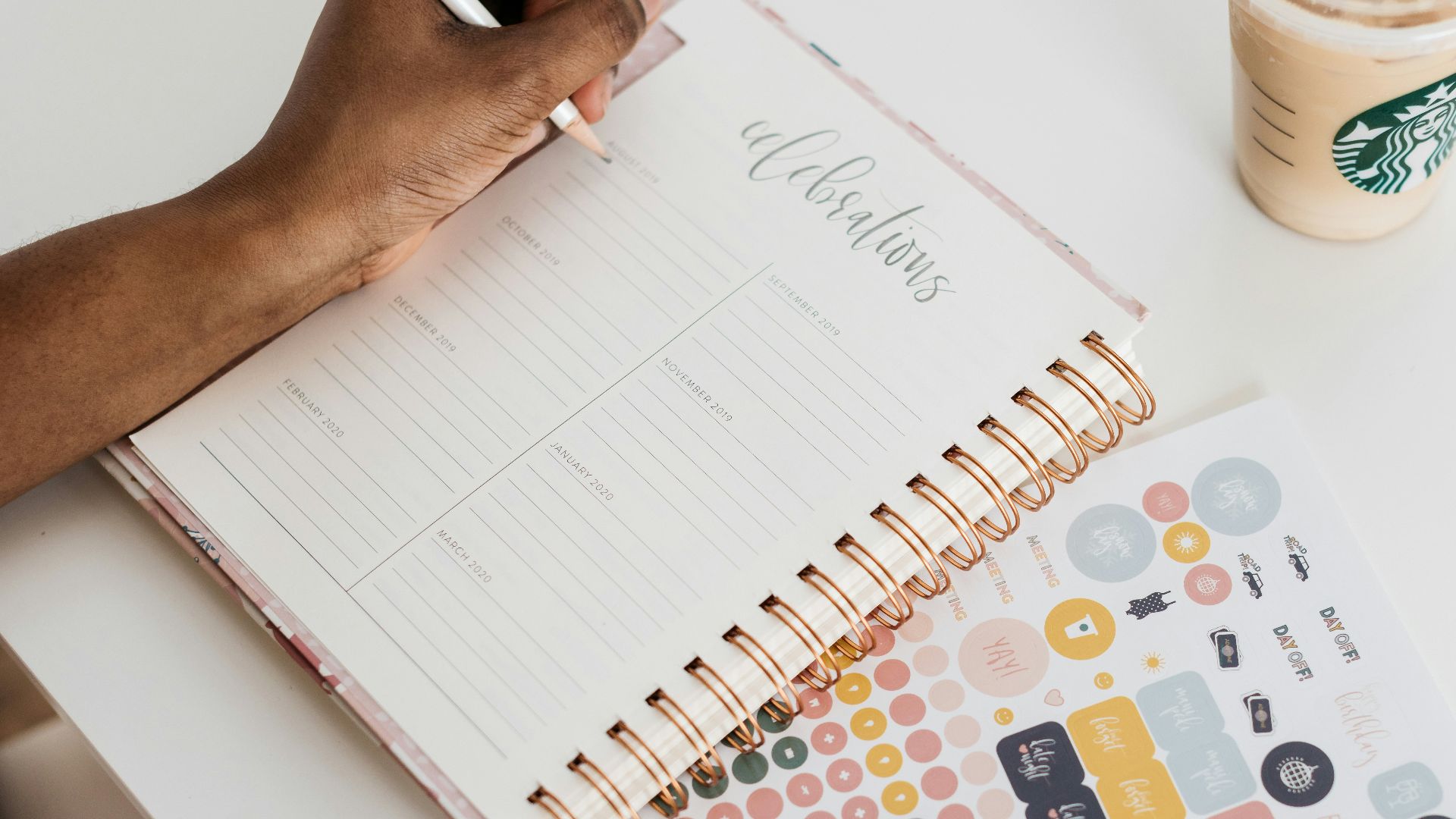 person writing at the tale