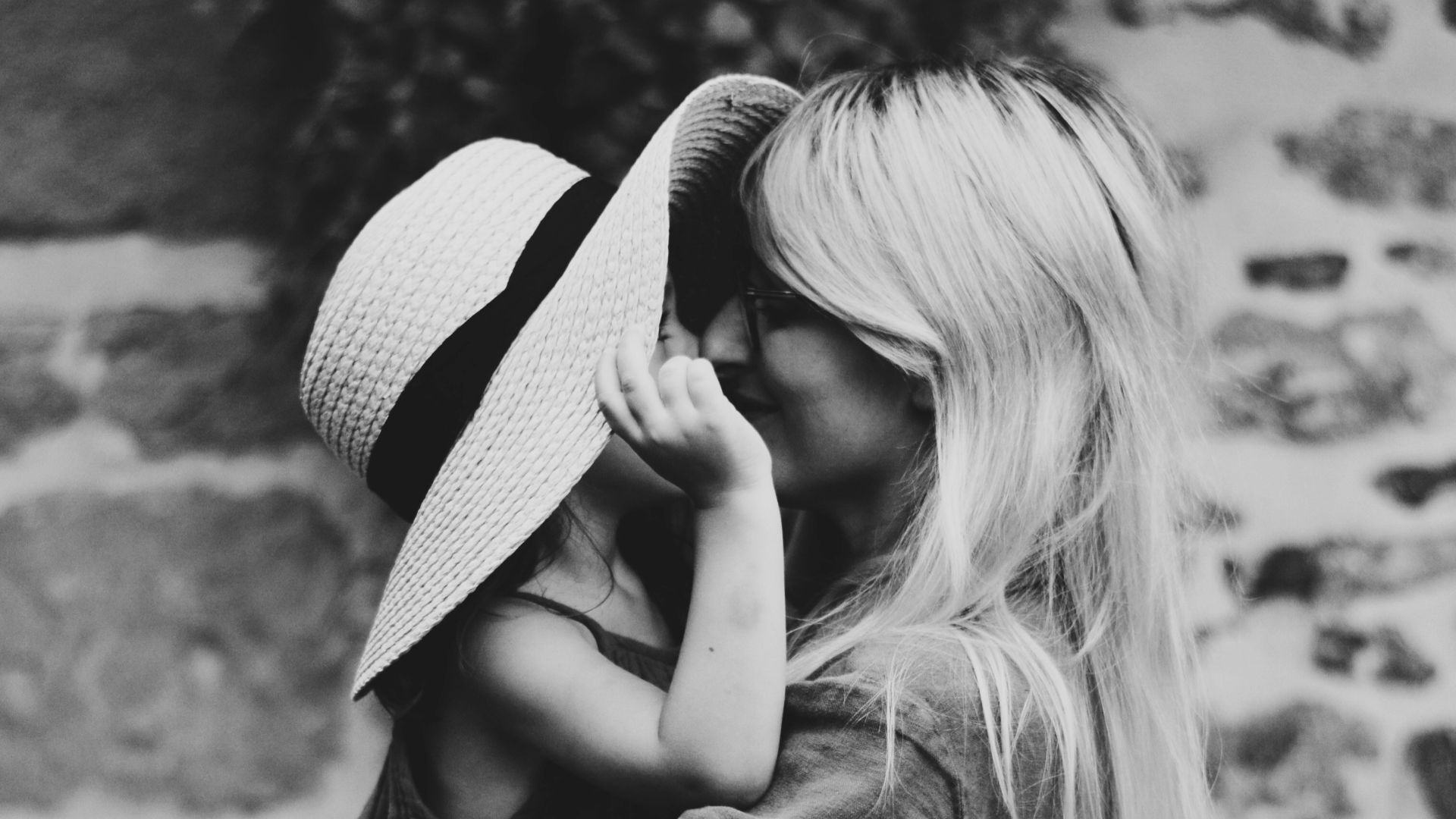 grayscale photography of woman carrying girl