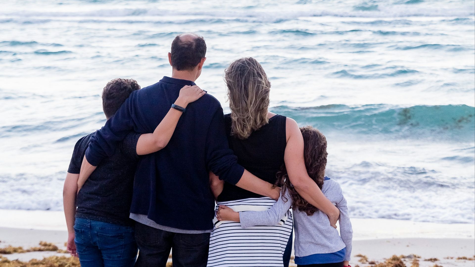 a family of four on a beach