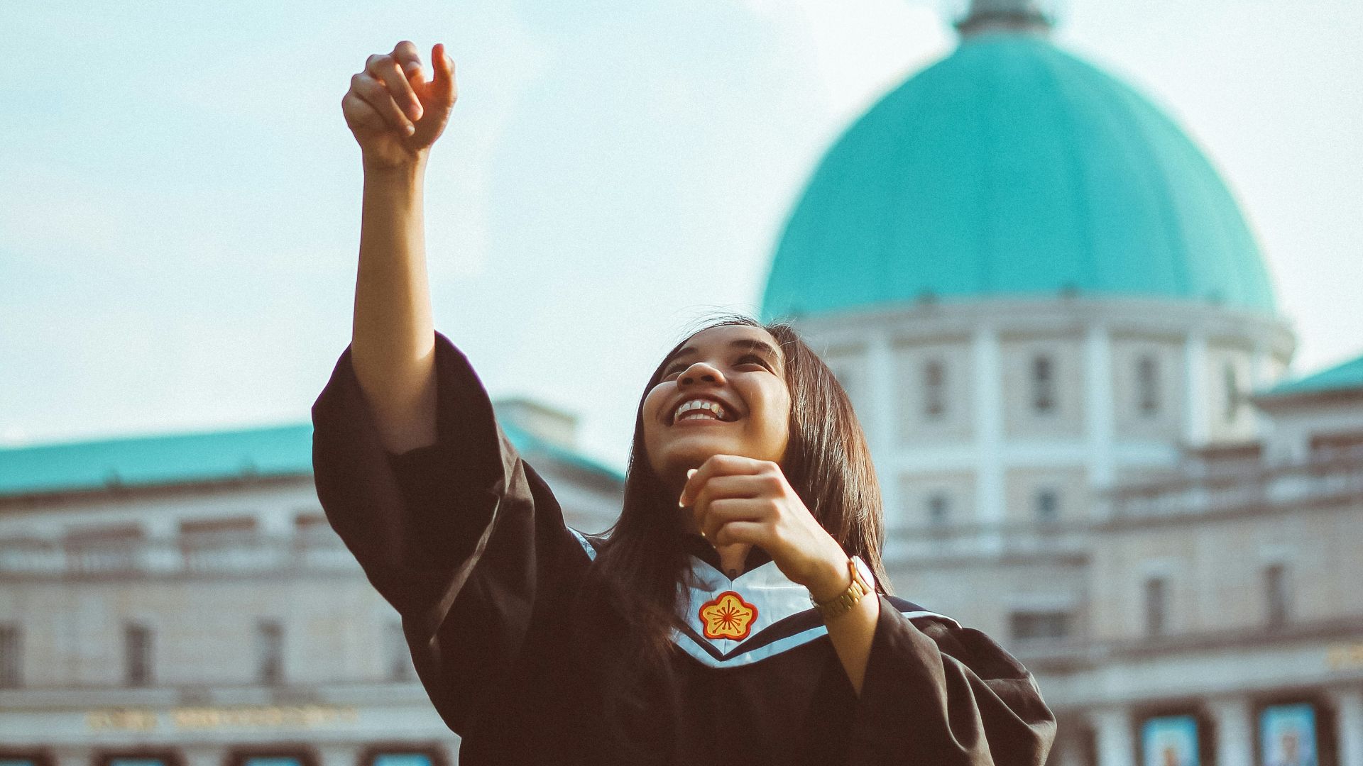 woman throwing her academic hat
