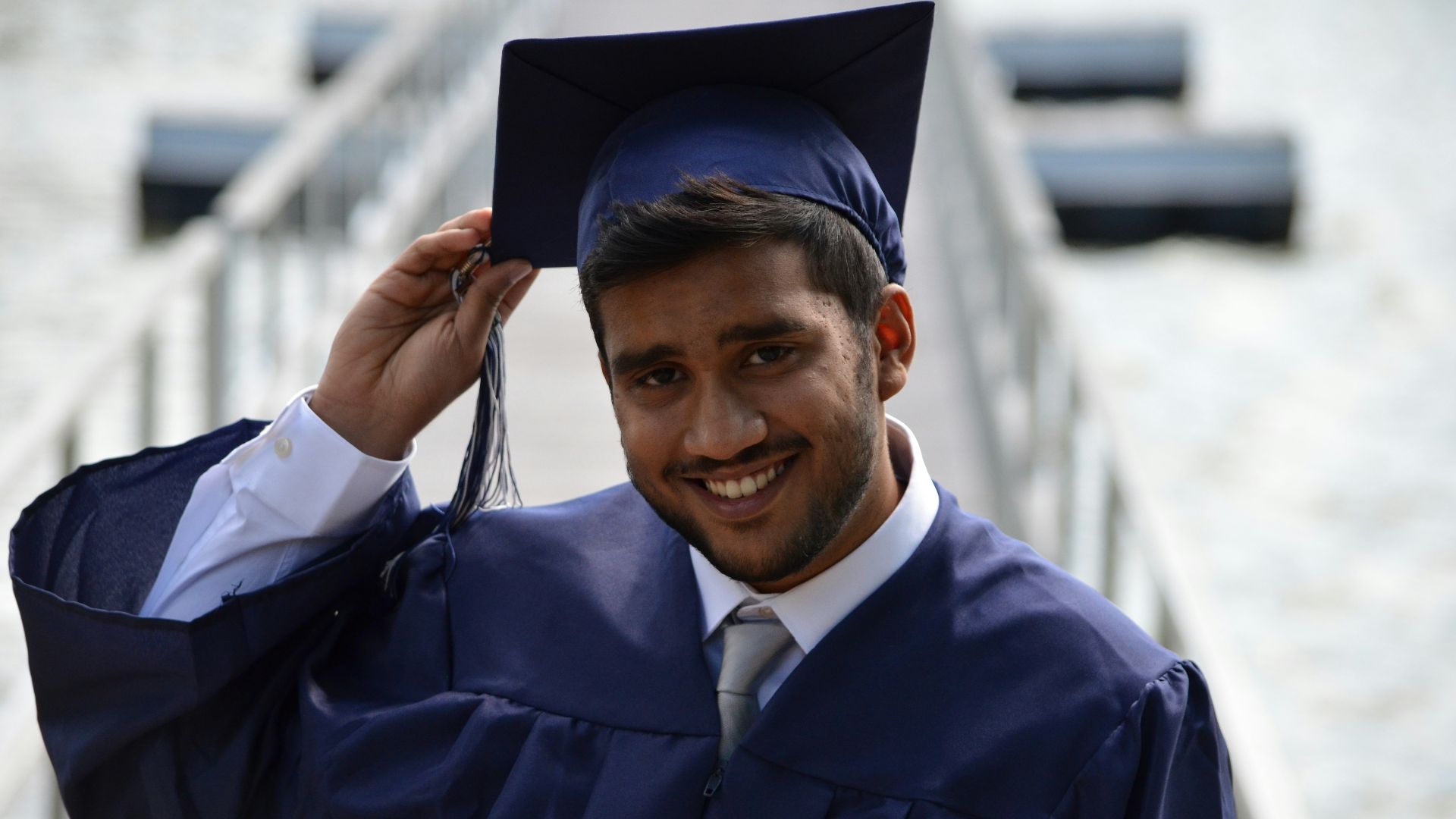man holding his graduation cap