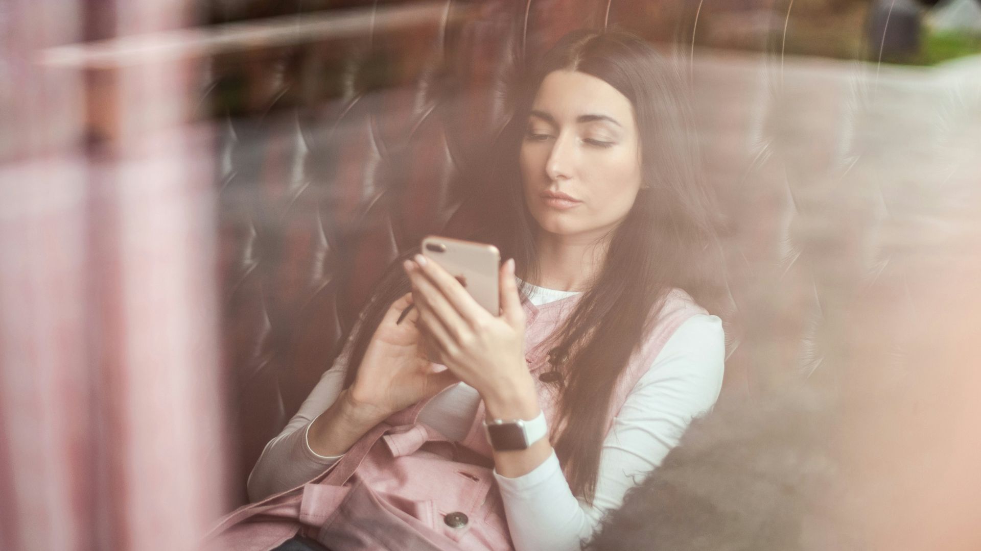 woman in white long sleeve shirt holding gold iphone 6