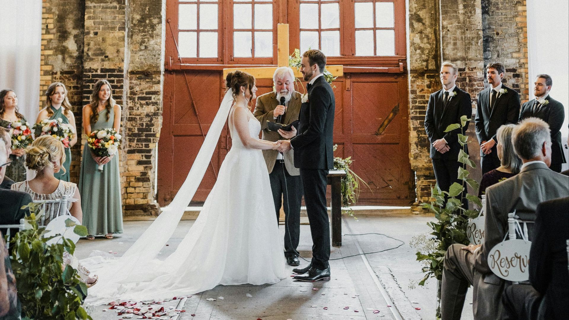 A bride and groom standing in front of a chandelier