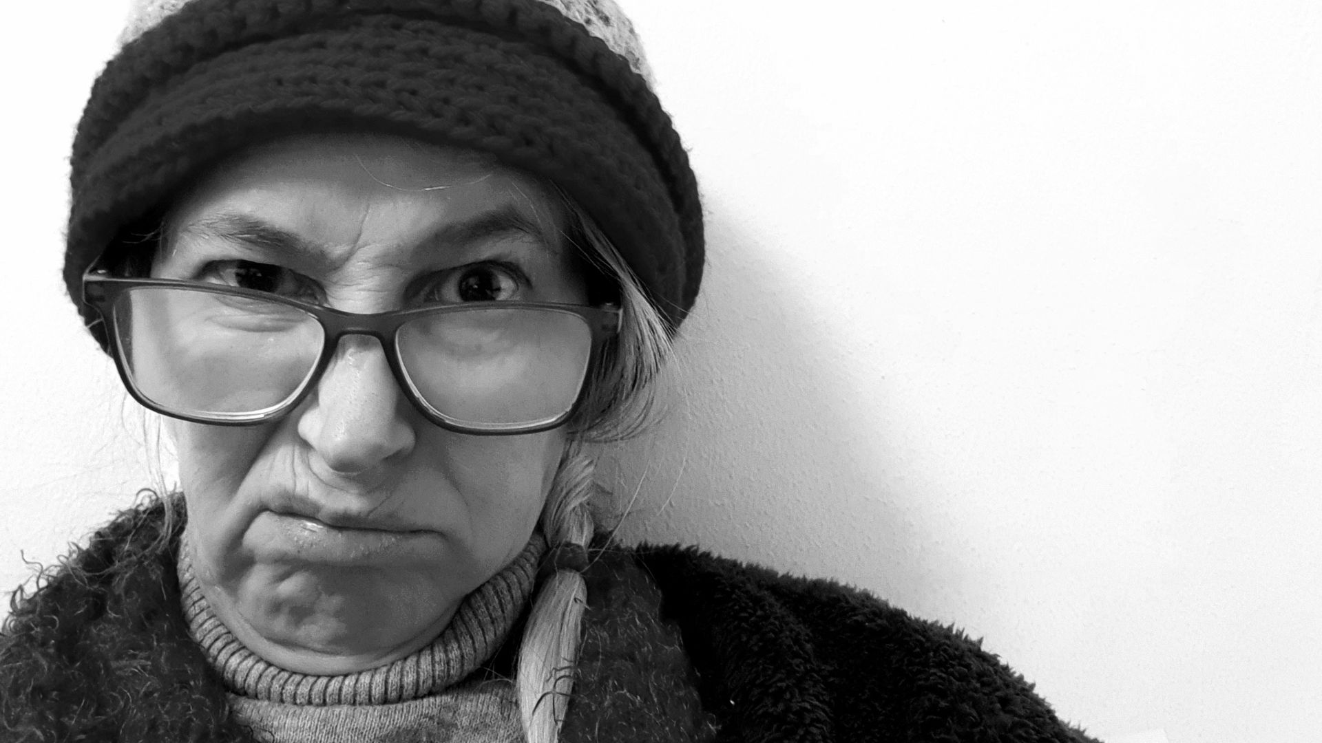 a man wearing glasses and a hat