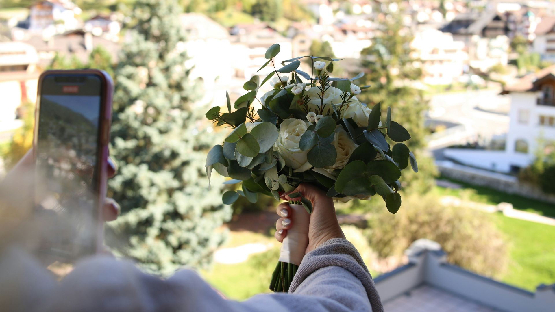 a person holding a bouquet of flowers in their hand