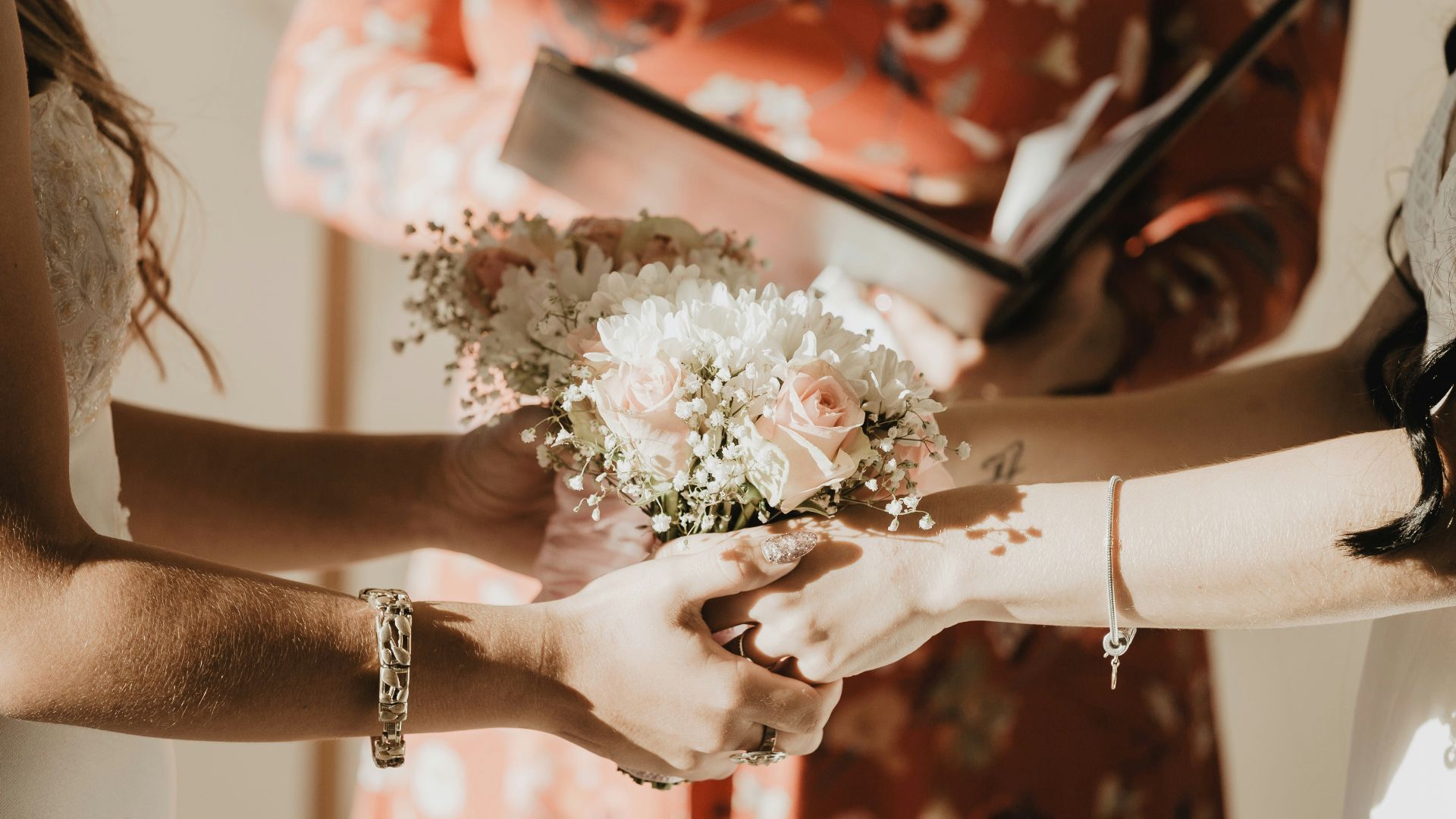 person holding white flower bouquet