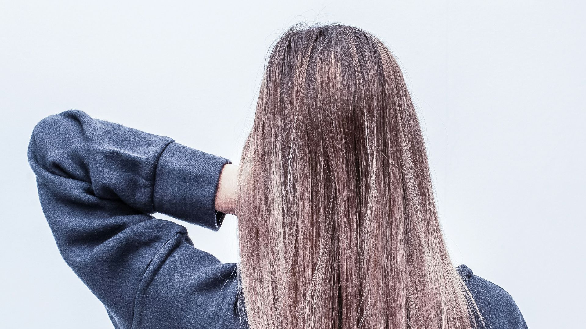 woman touching her hair