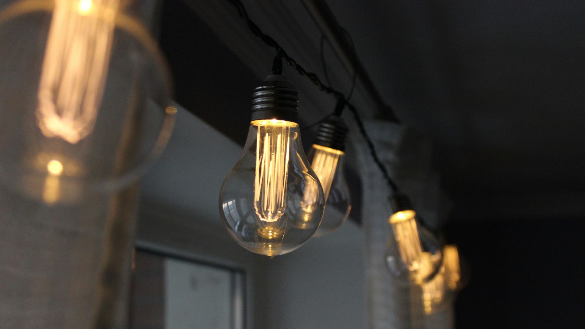 clear glass light bulb turned on in room