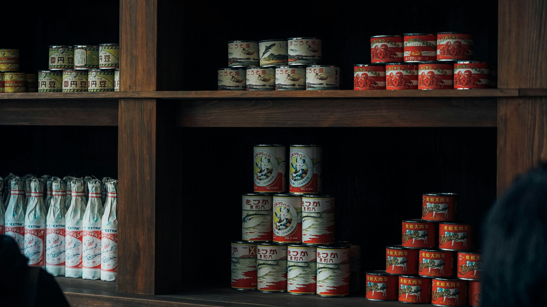 a shelf with many cans of food on it