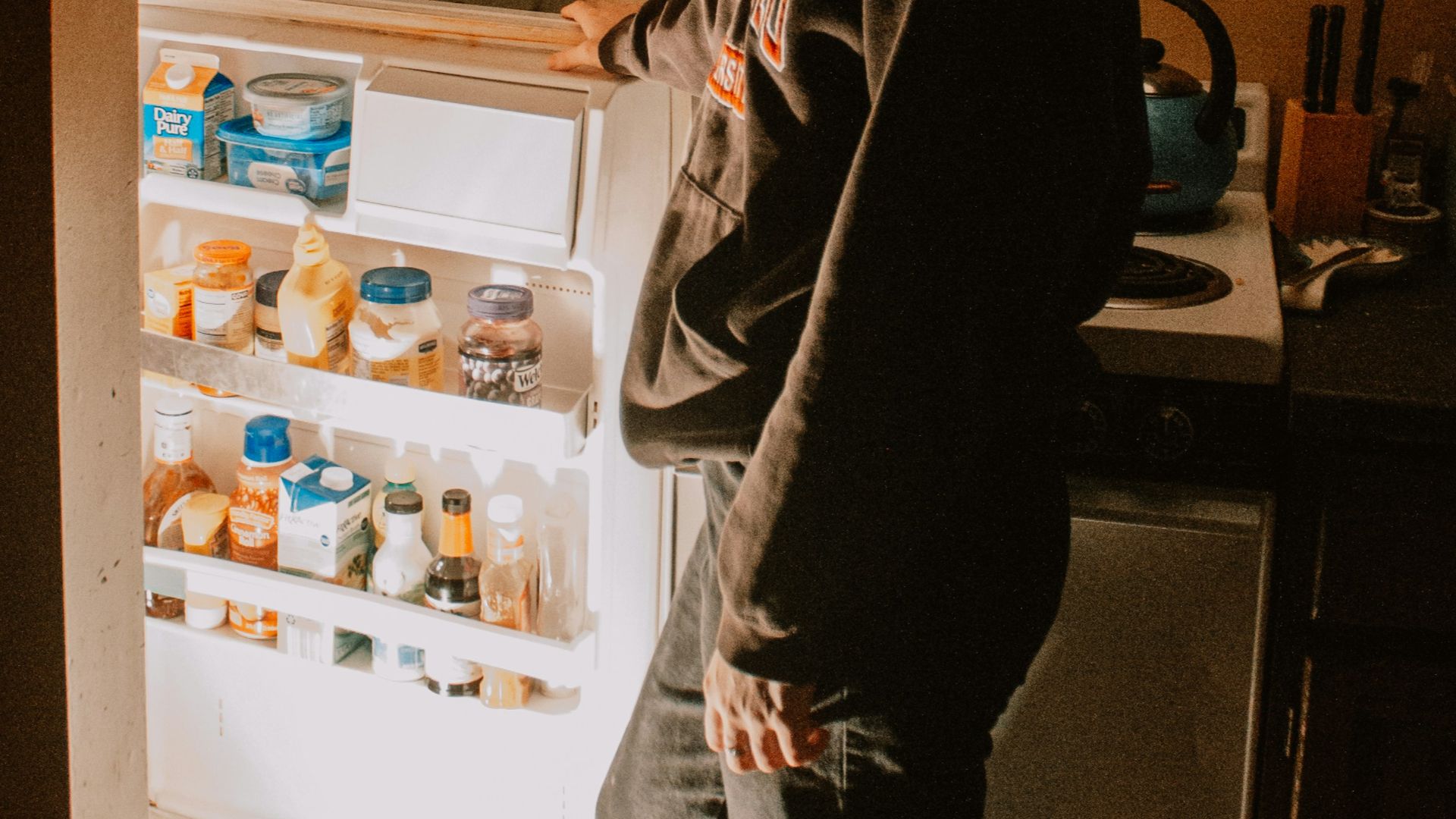 a person opens a refrigerator