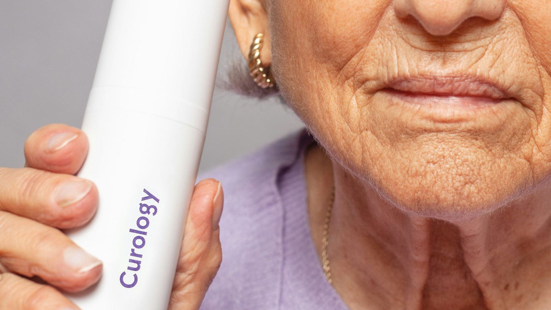 woman holding Curology bottle