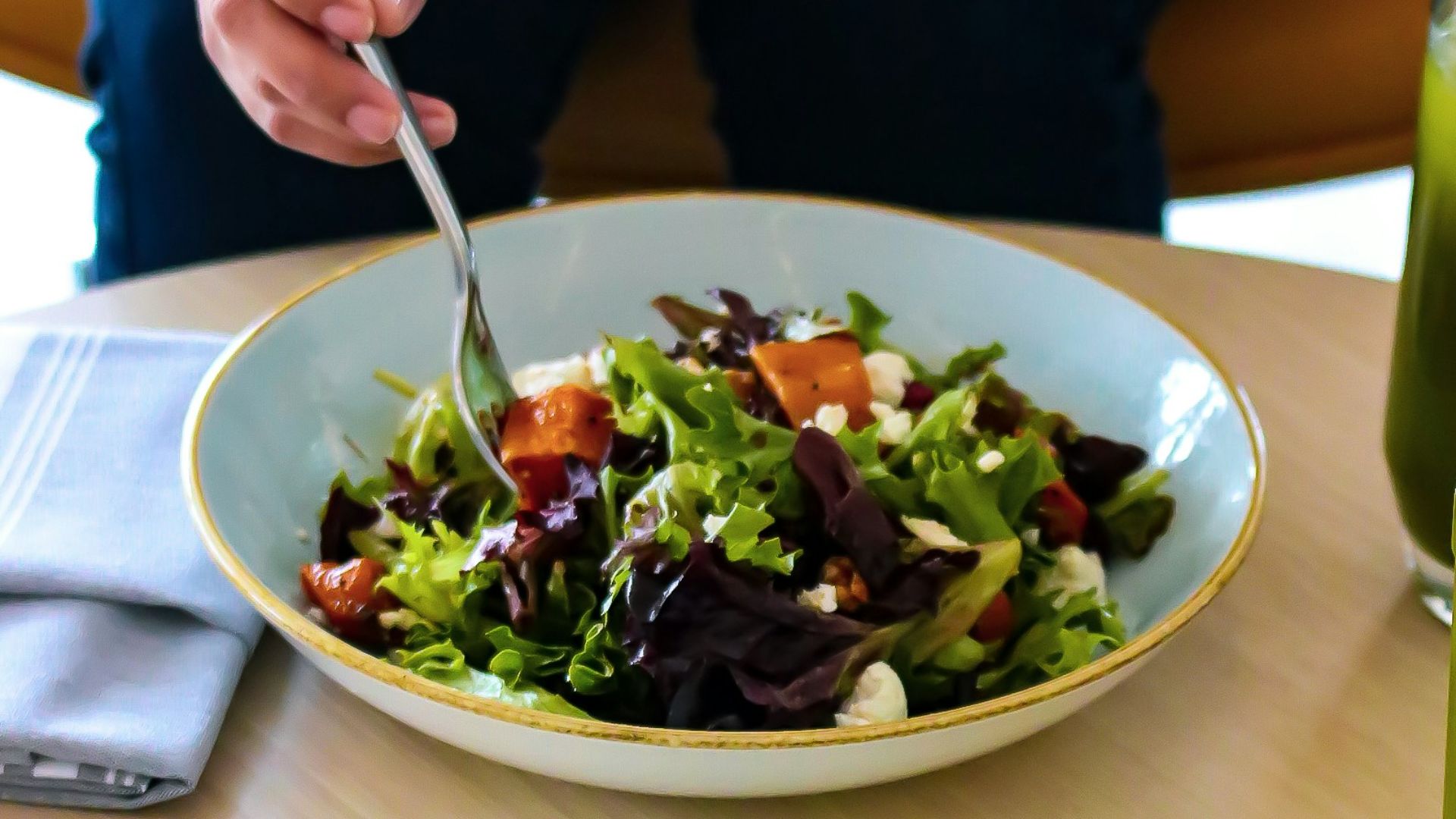 person holding silver fork and knife