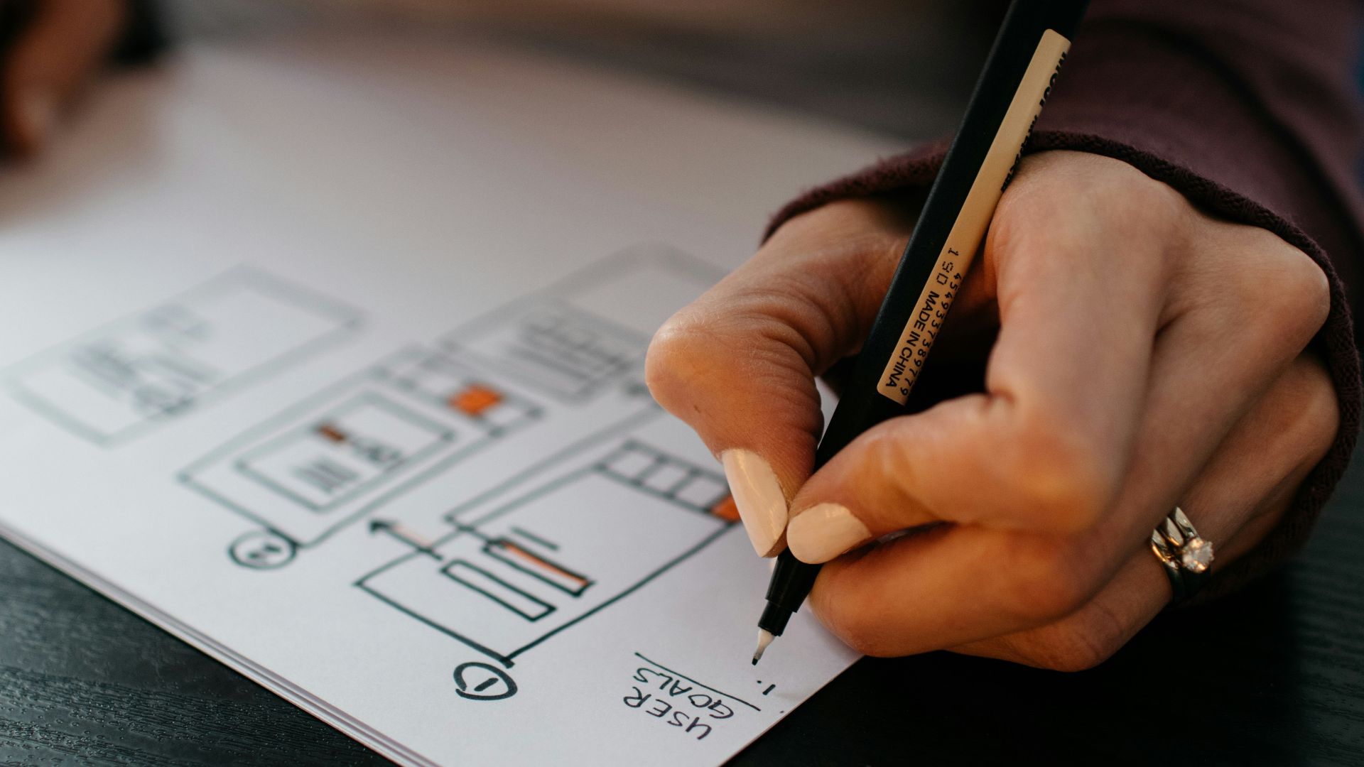 person writing on white paper