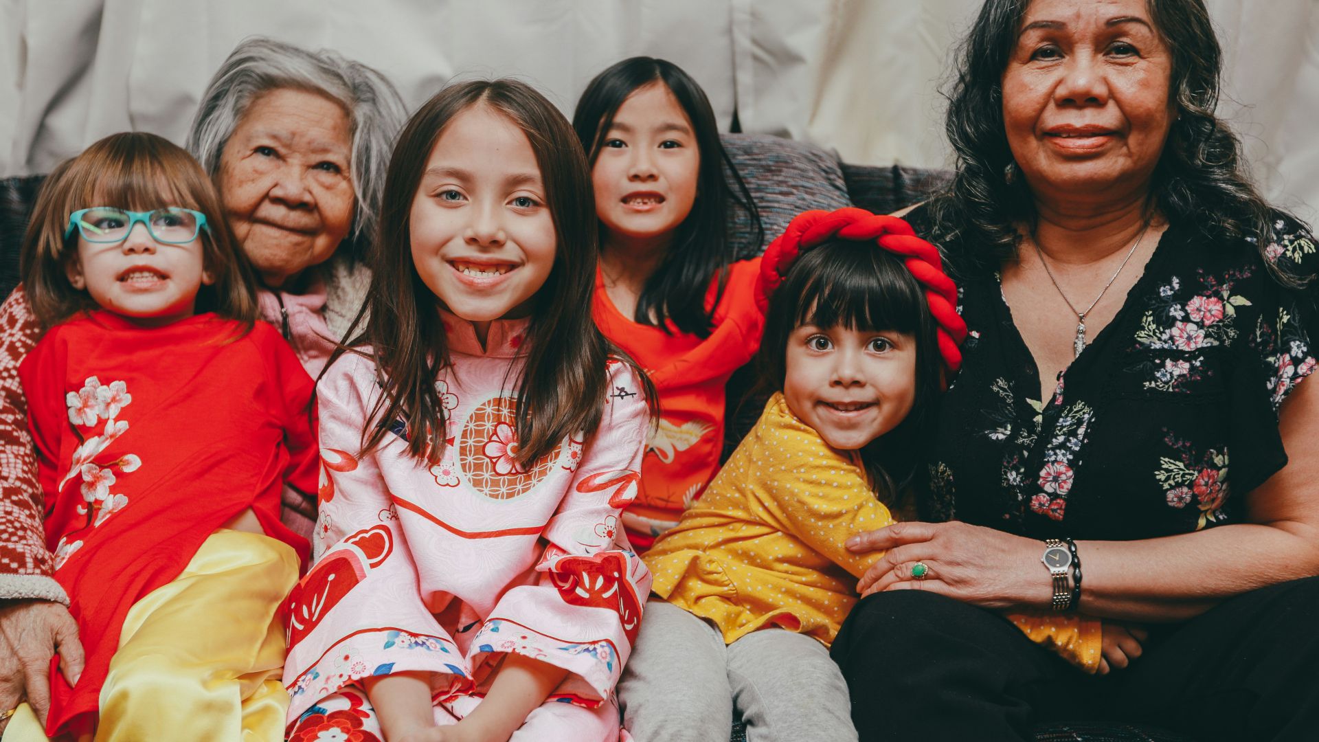 a group of women sitting next to each other on a couch