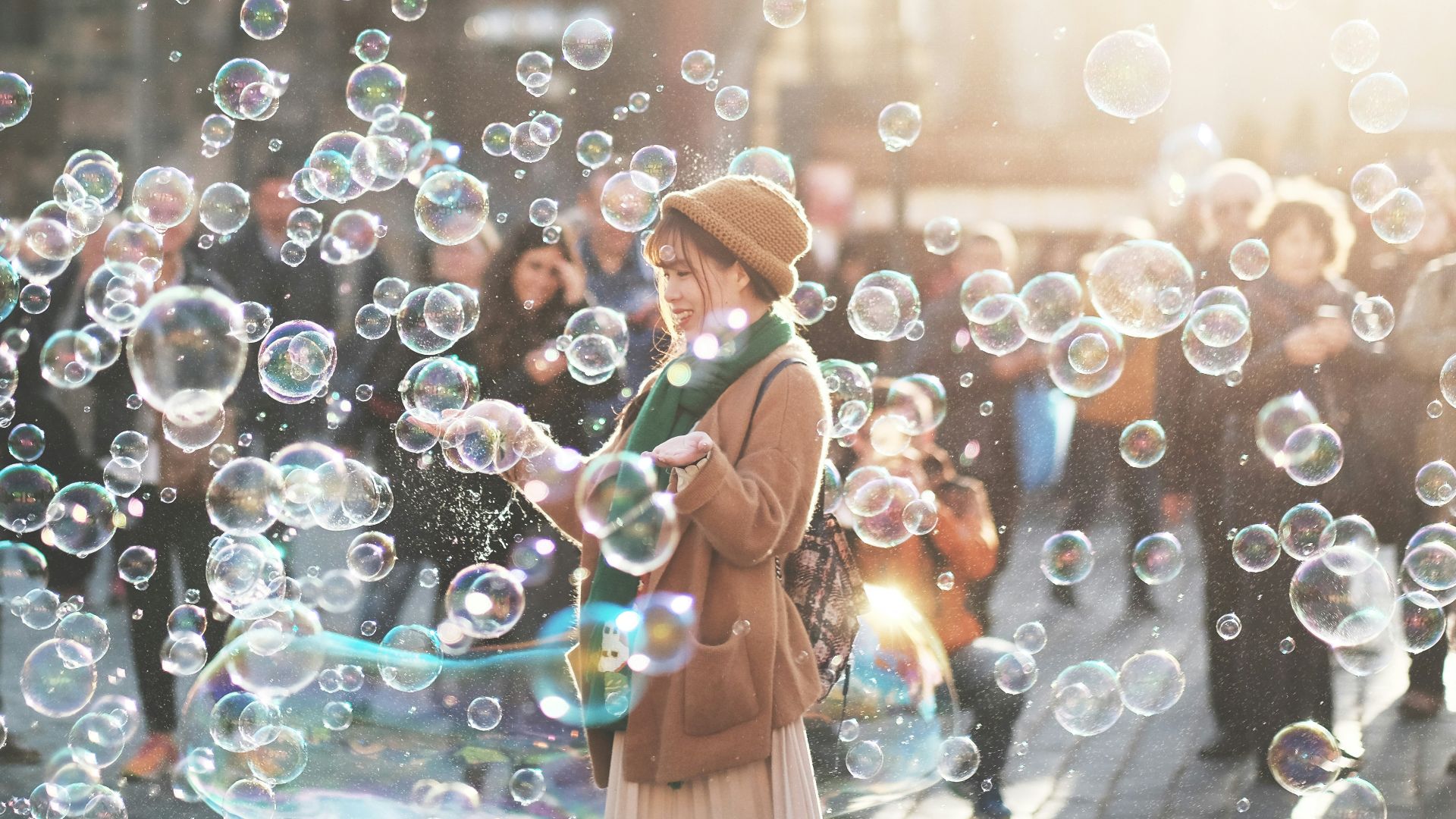 woman standing outdoor surrounded by bobbles during daytime