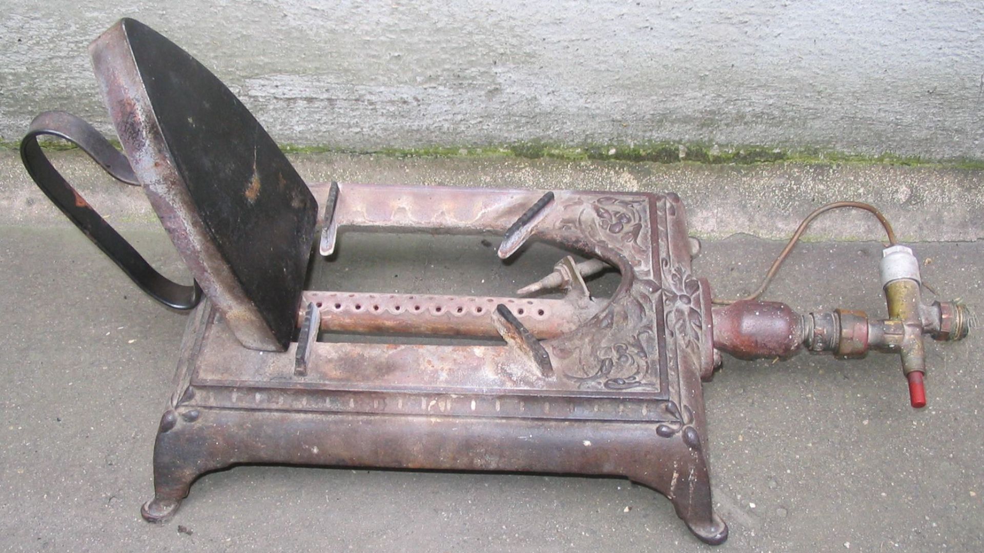 File:Old gas iron heater in a furrier's and headmaker's shop.jpg