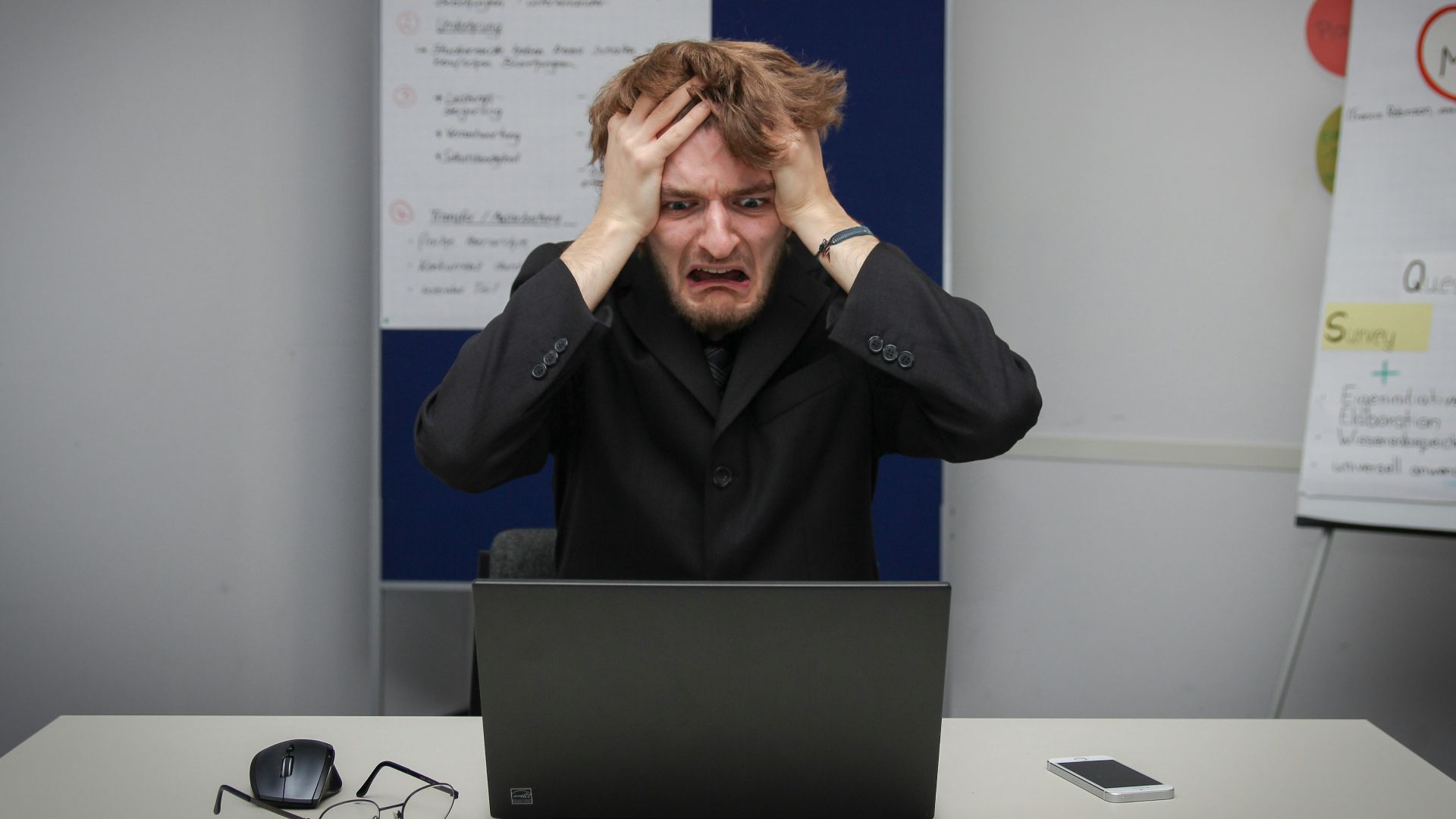 A man sitting in front of a laptop computer