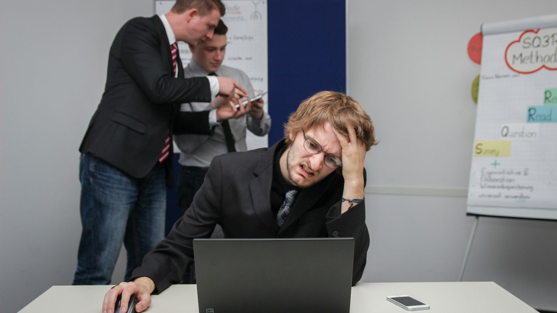 A man sitting in front of a laptop computer