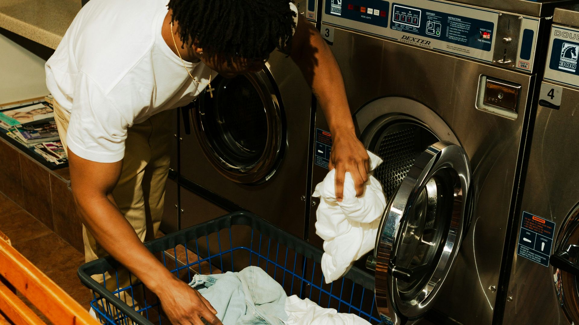 woman in white t-shirt washing dishes