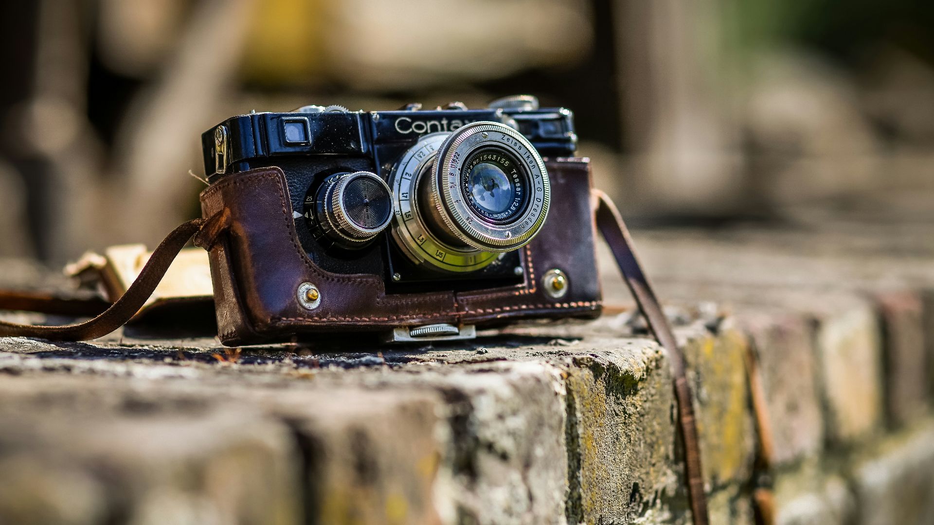 black SLR camera on brown brick surface
