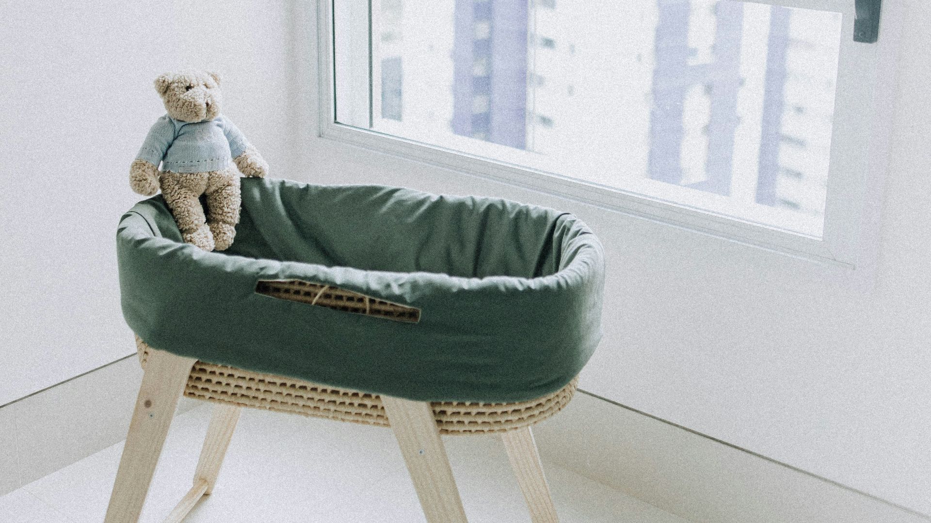 woman in green sweater lying on bed