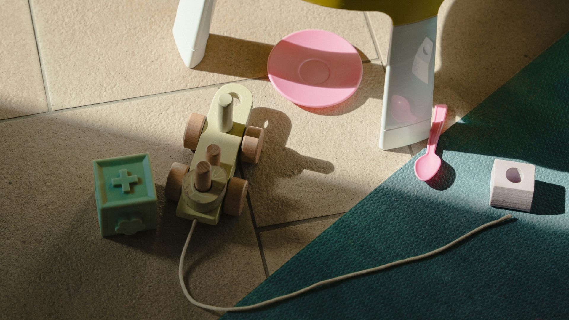 a yellow chair with a pink plastic cup and a green plastic container