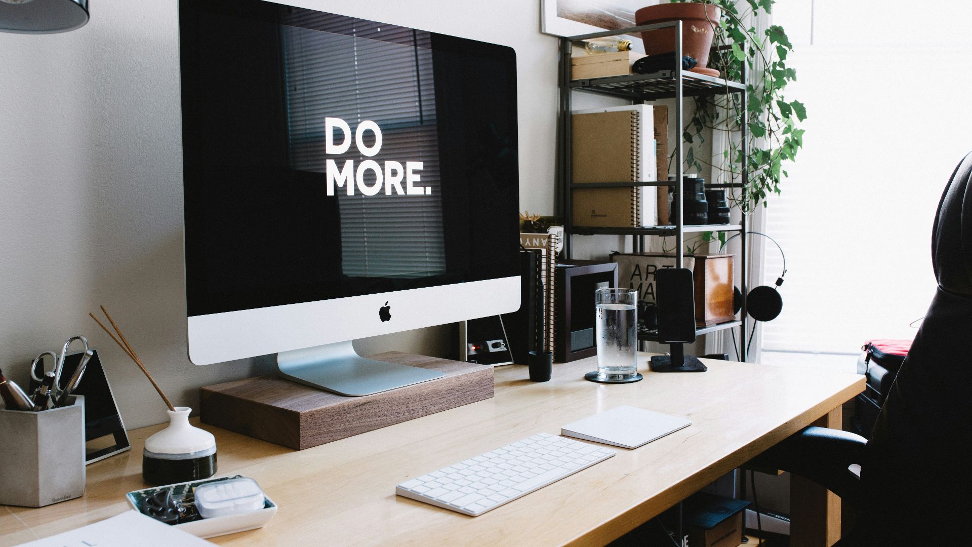 silver iMac with keyboard and trackpad inside room