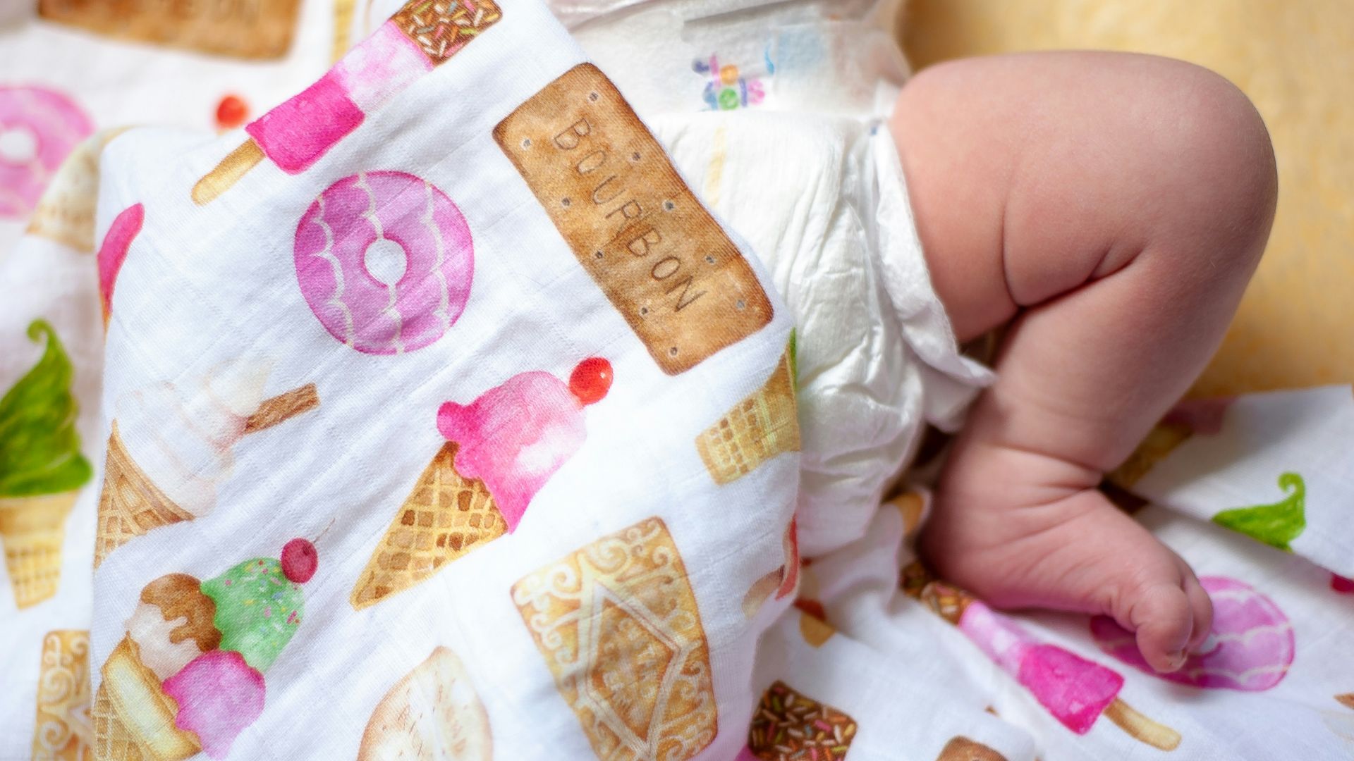 baby in white and pink floral onesie