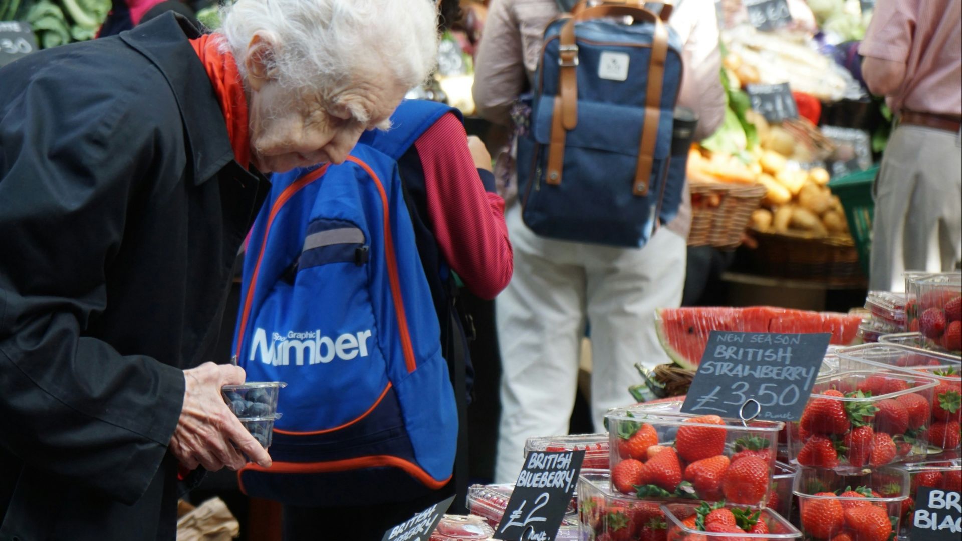 man in blue jacket standing beside woman in blue jacket